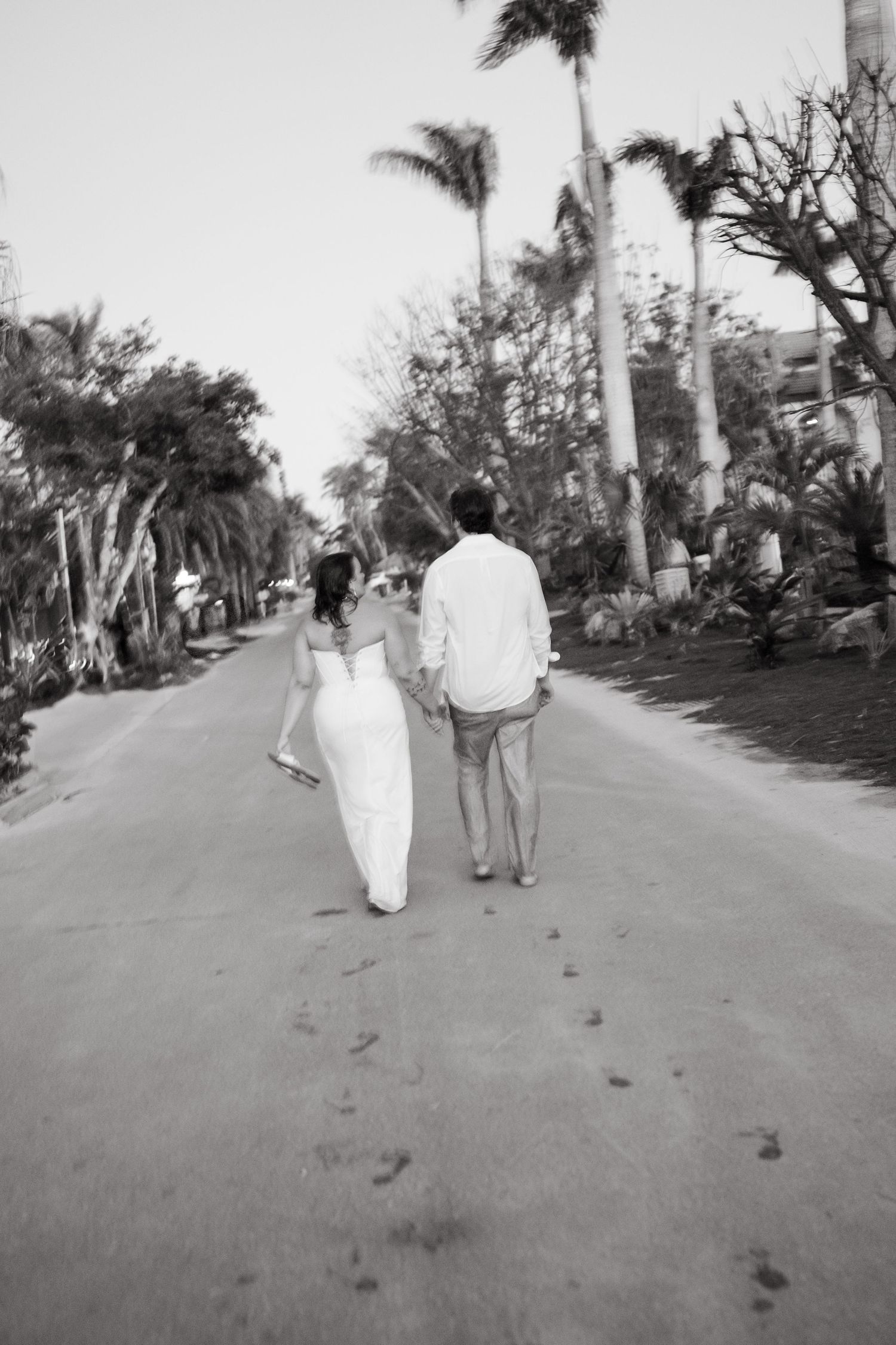 guy and girl walking away in black and white blurred photo