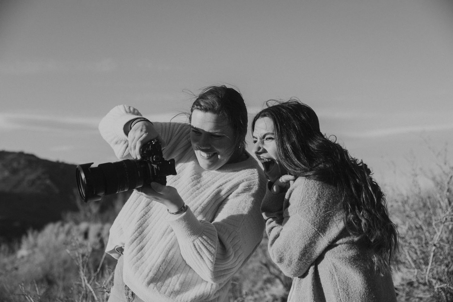 A series of black and white film stills showing romantic moments between two people in a field.
