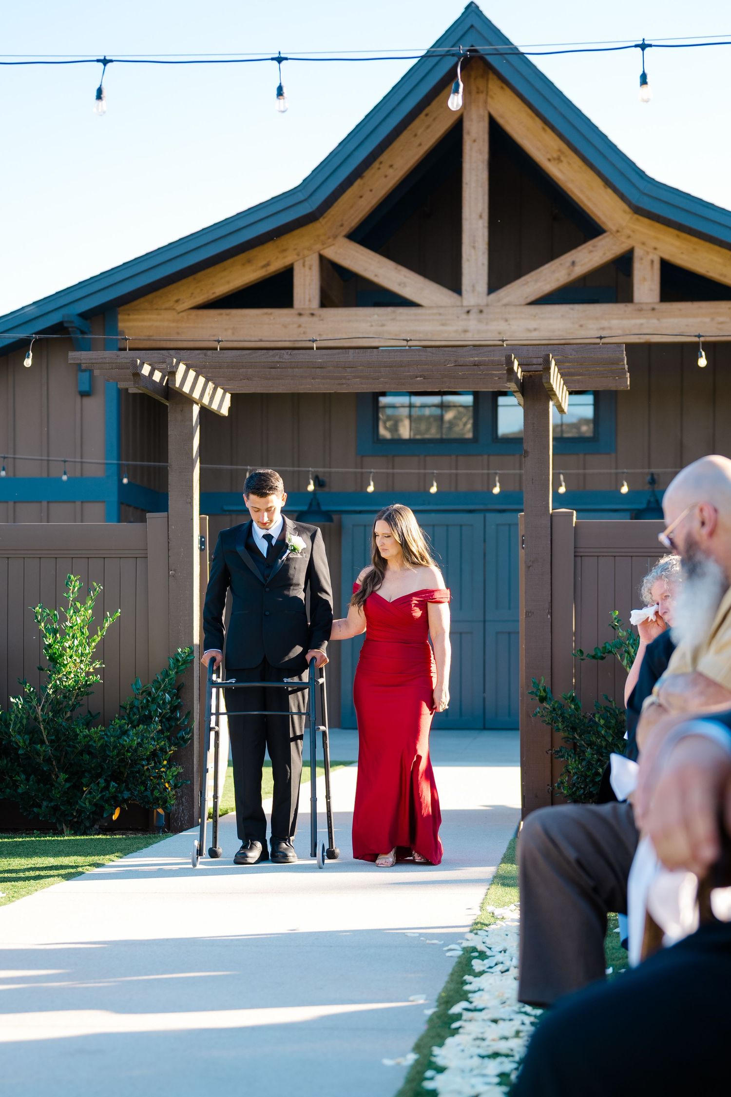 Neven Hart walking down the aisle at his wedding to Amber Hart at Canopy Grove in Escondido, California, photographed by Sierra Sturt Photo.