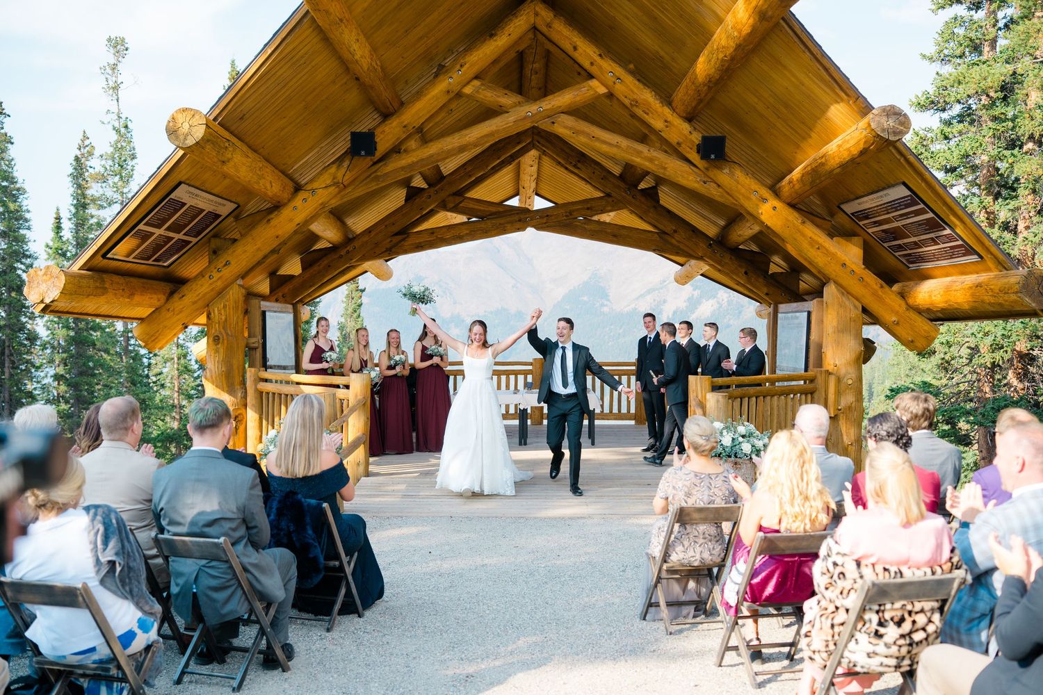 Copper mountain wedding - A series of outdoor wedding ceremony photos showing guests seated under wooden pavilions in a mountain setting.