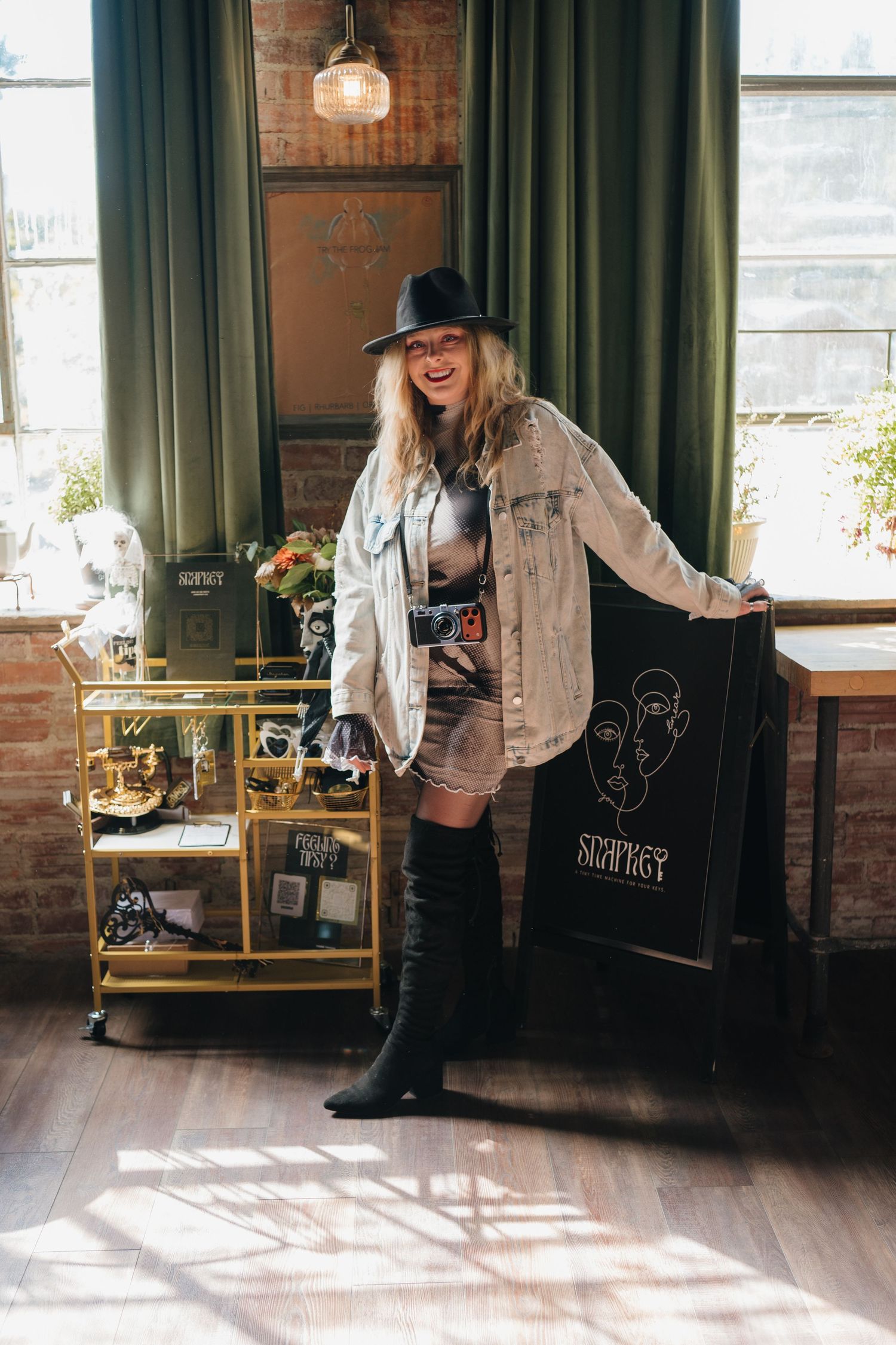 Owner of Snap Key standing in front of her booth at the Kansas City Wedding Guild Luncheon with Kansas City Engaged