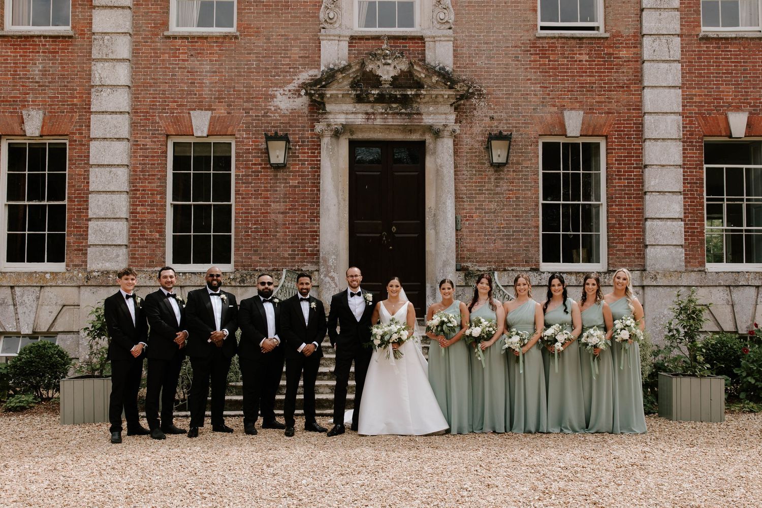 Bride and groom group portraits at Deans Court in Wimborne, Dorset.