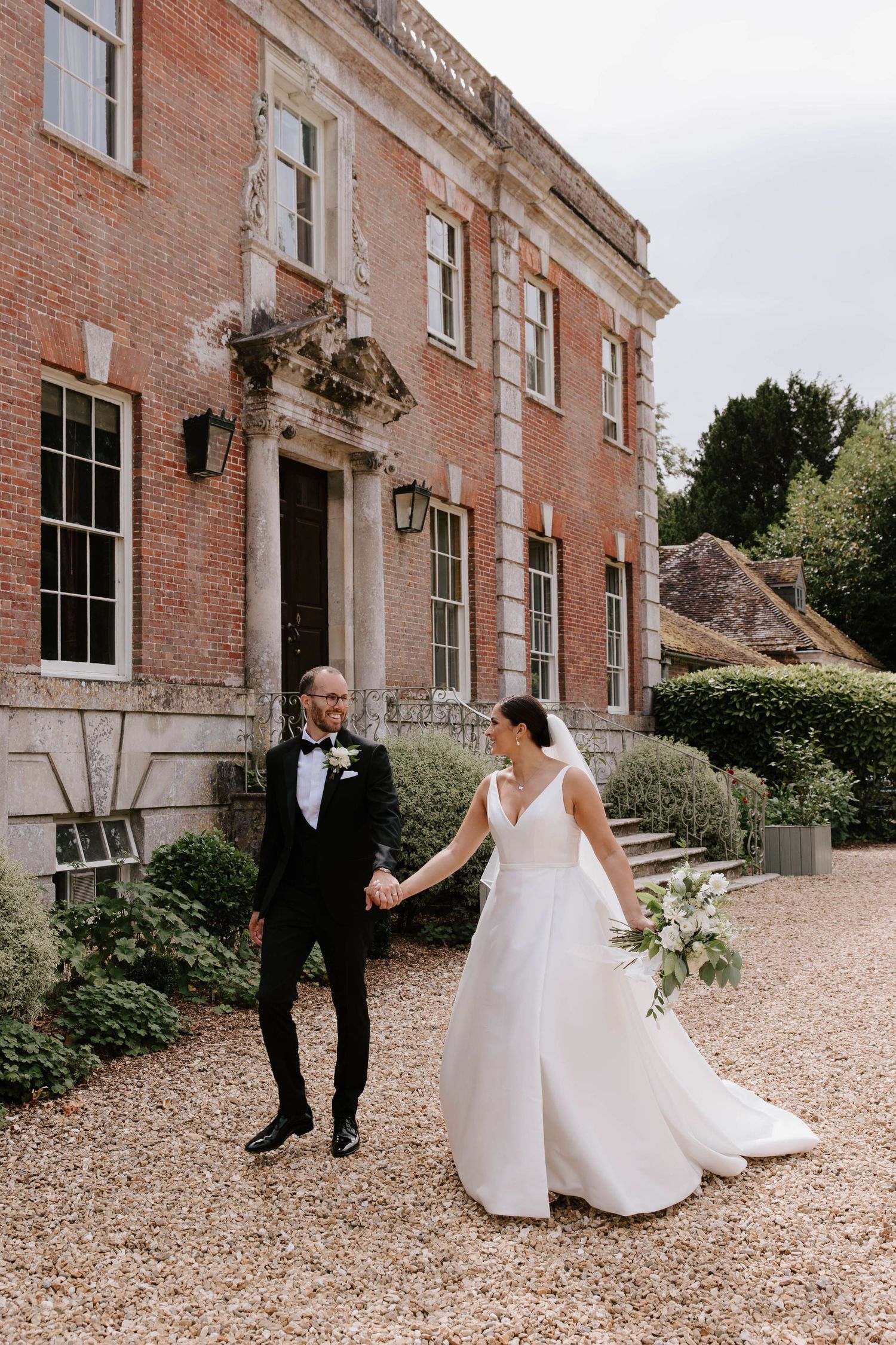 Bride and groom having couple portraits at Deans Court in Wimborne, Dorset.