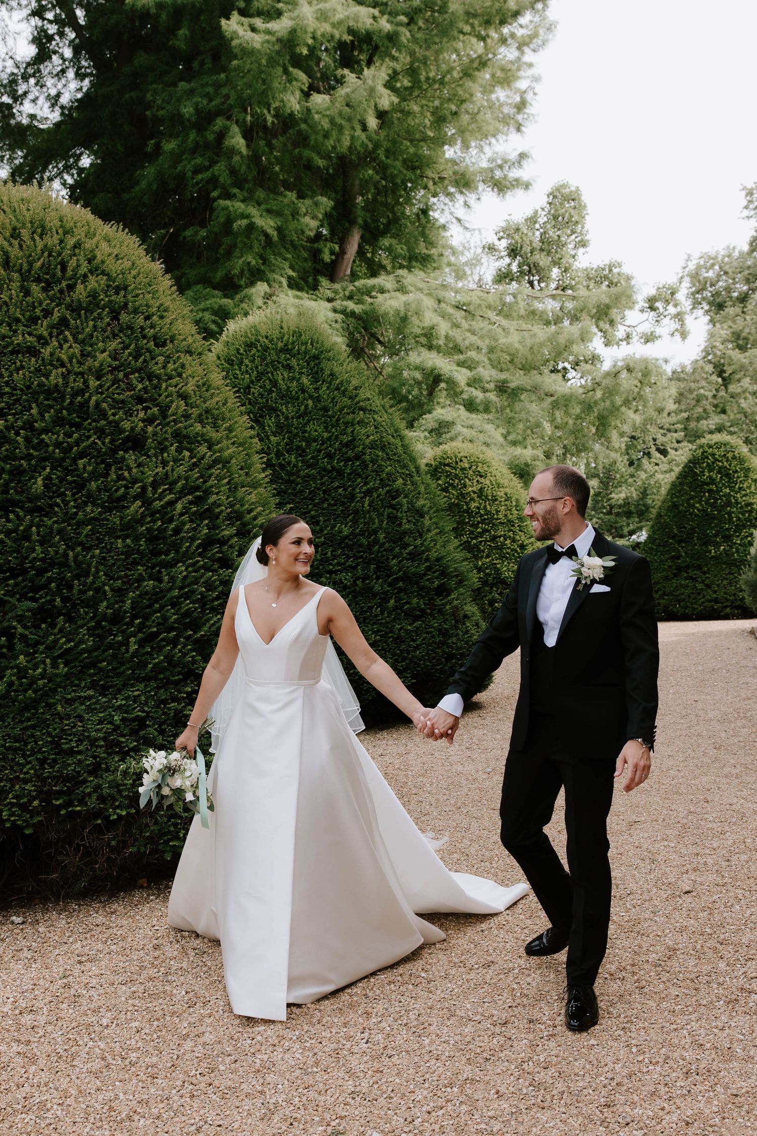Wedding day at Deans Court Dorset, Hampshire. Couple having portraits taken on their wedding day.