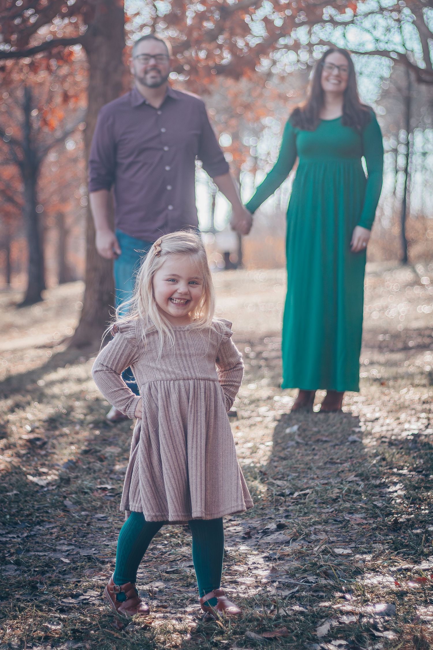 A series of outdoor family photos captured in autumn with people wearing green and brown outfits among fallen leaves.