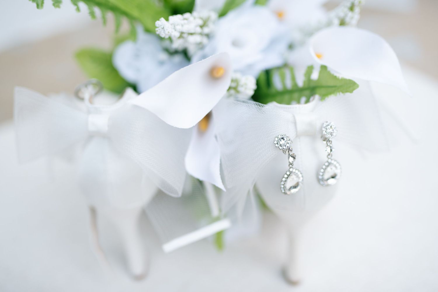 Delicate white narcissus flowers with green stems against a soft blurred background.  wedding photography