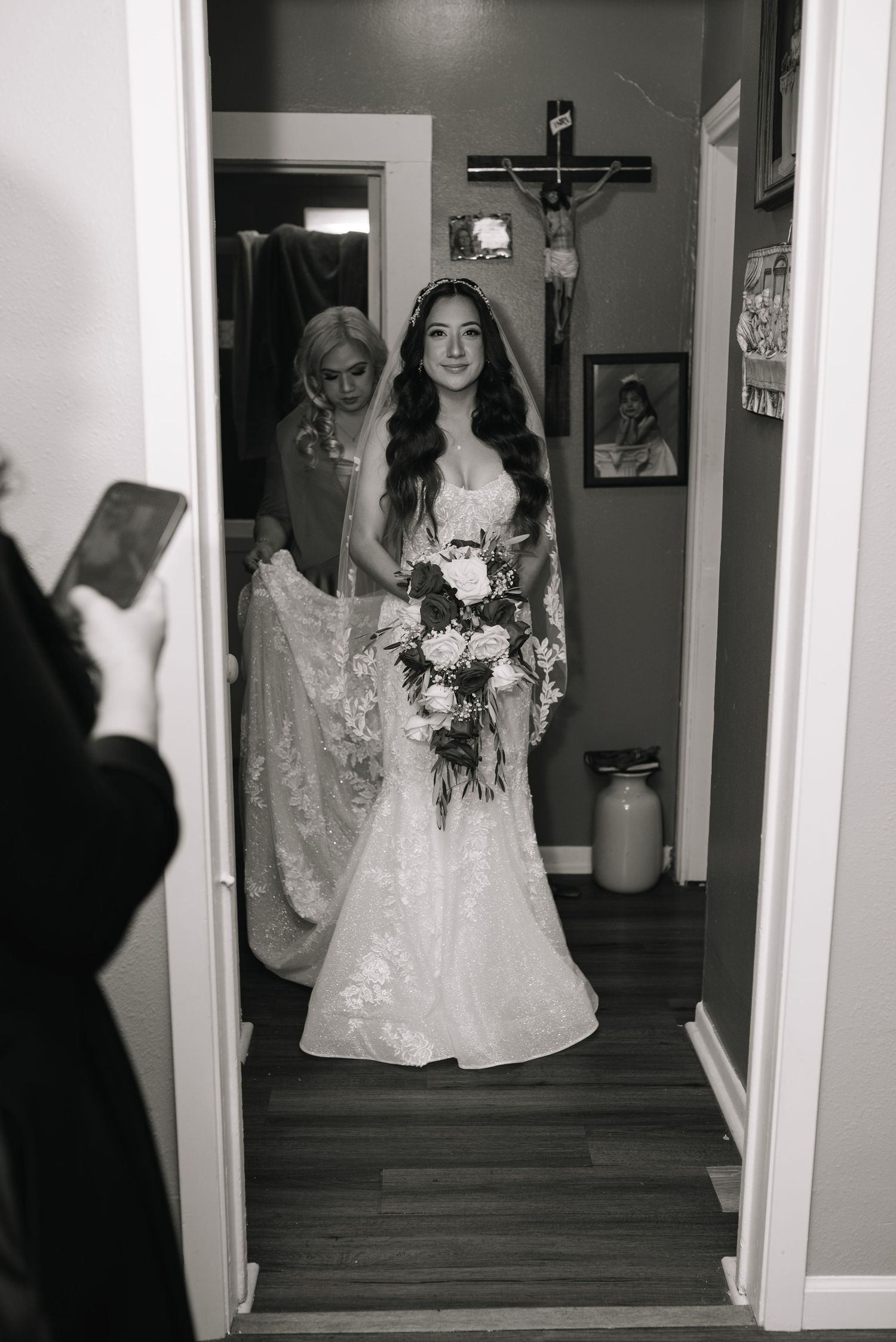 A sequence of black and white photos showing a ghostly figure in a white dress moving through a dimly lit hallway.