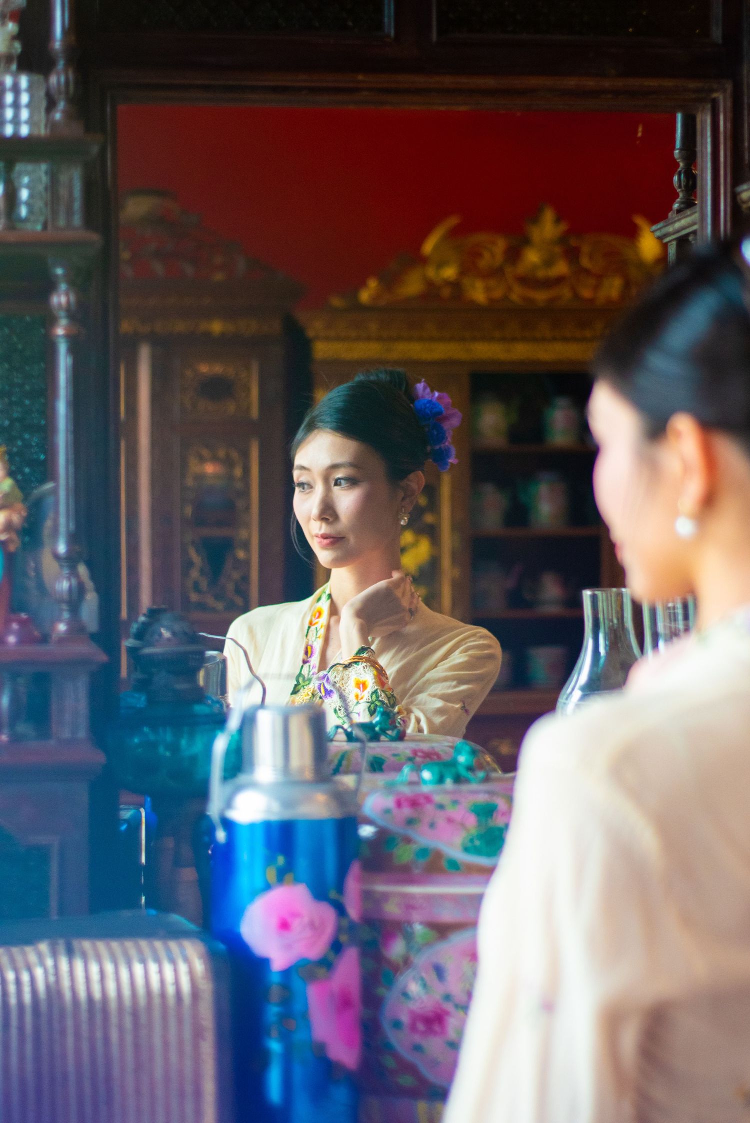 Traditional tea ceremony setting with ornate decorative elements and blue lighting in an Asian cultural space.