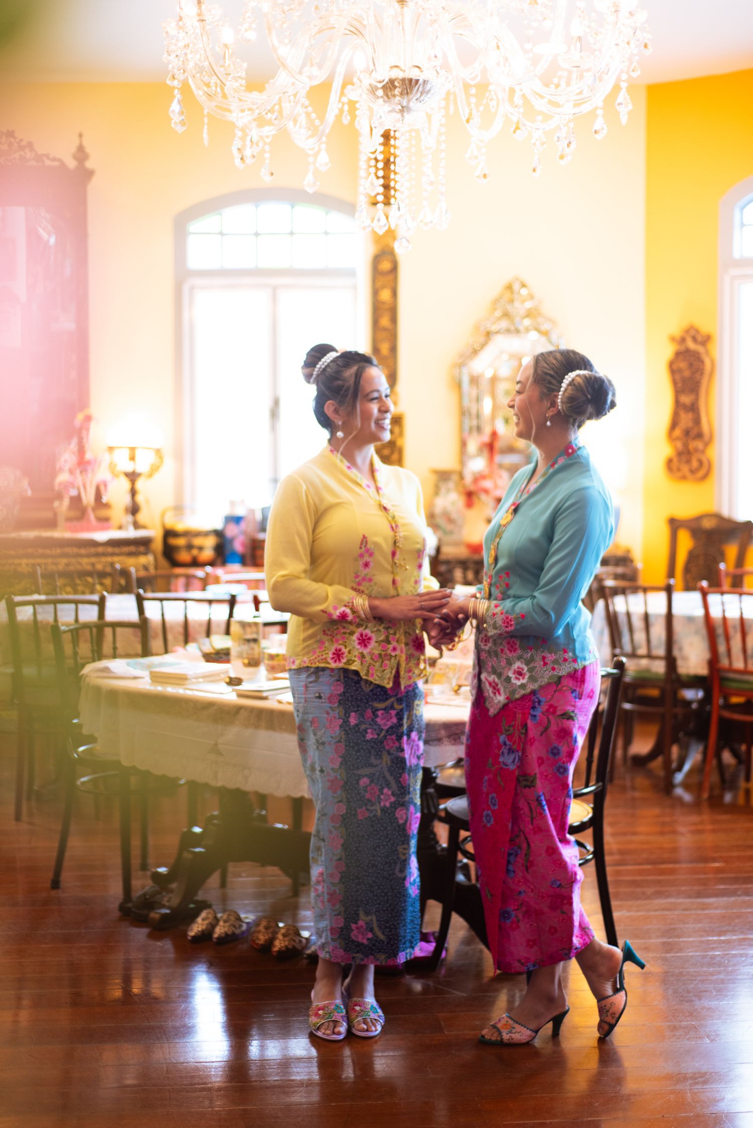 Elderly residents dancing together in a sunlit nursing home activity room with vintage decor and warm lighting.