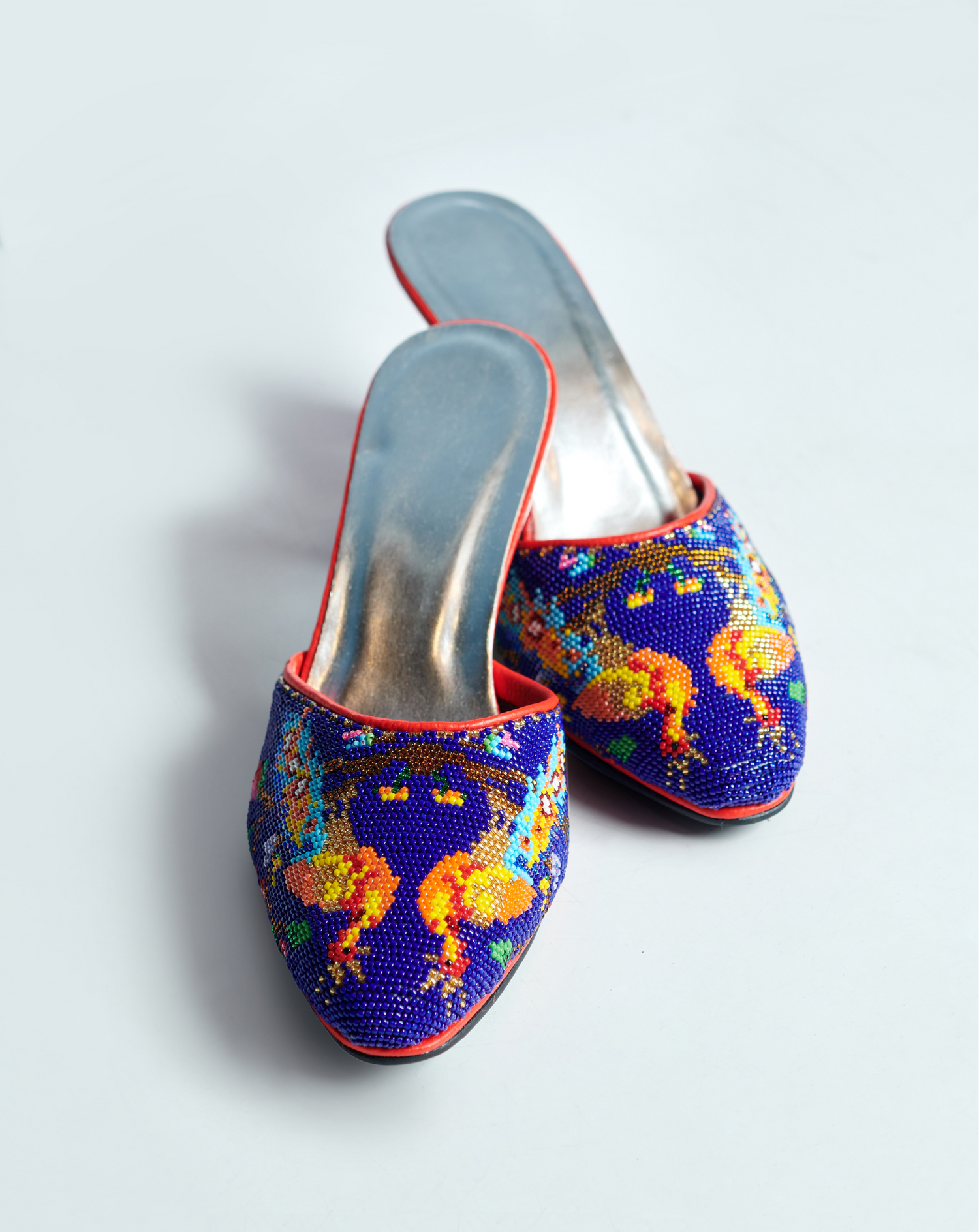 Traditional Nyonya beaded slippers with colorful floral embroidery in royal blue and orange. Also known as Kasot Manek or Masut Manik