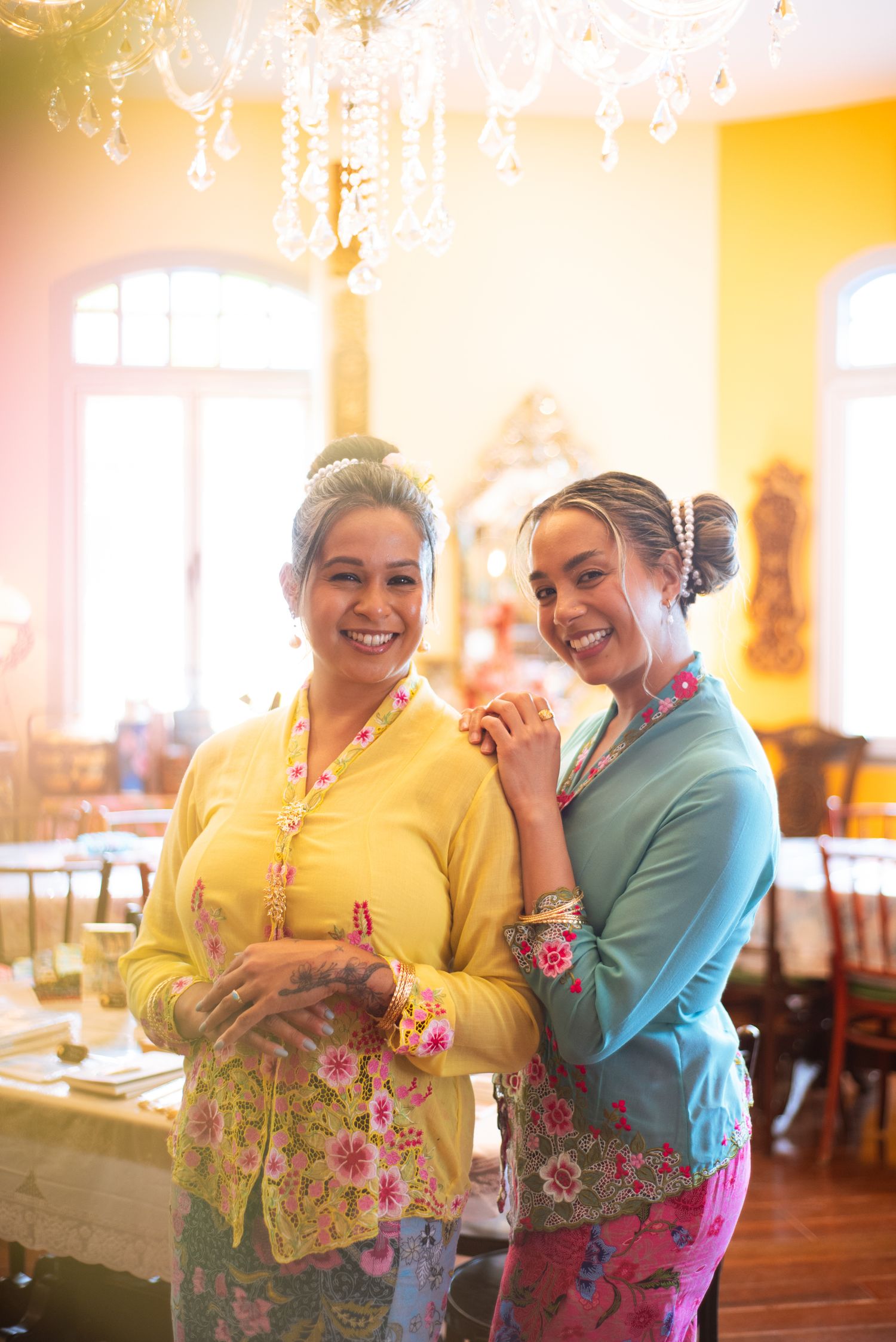 Series of warm-toned candid photos showing joyful interaction between two people in bright yellow and blue clothing.