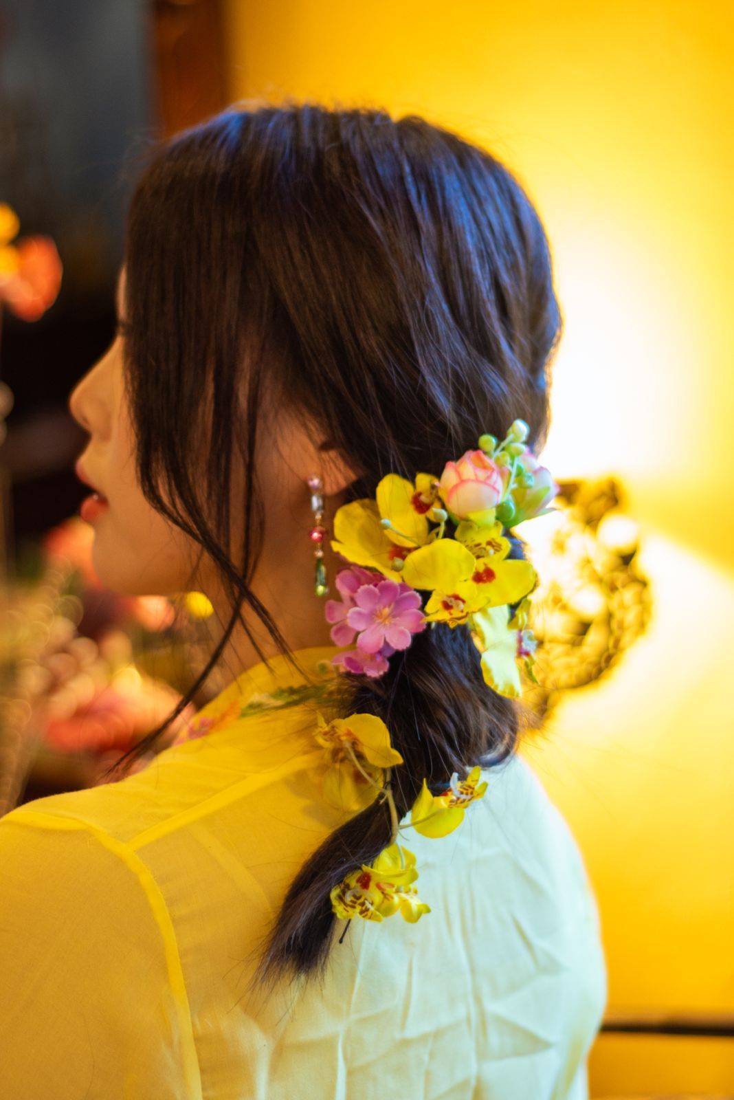 A side profile adorned with colorful yellow and pink flowers against a warm glowing background set in sequence.