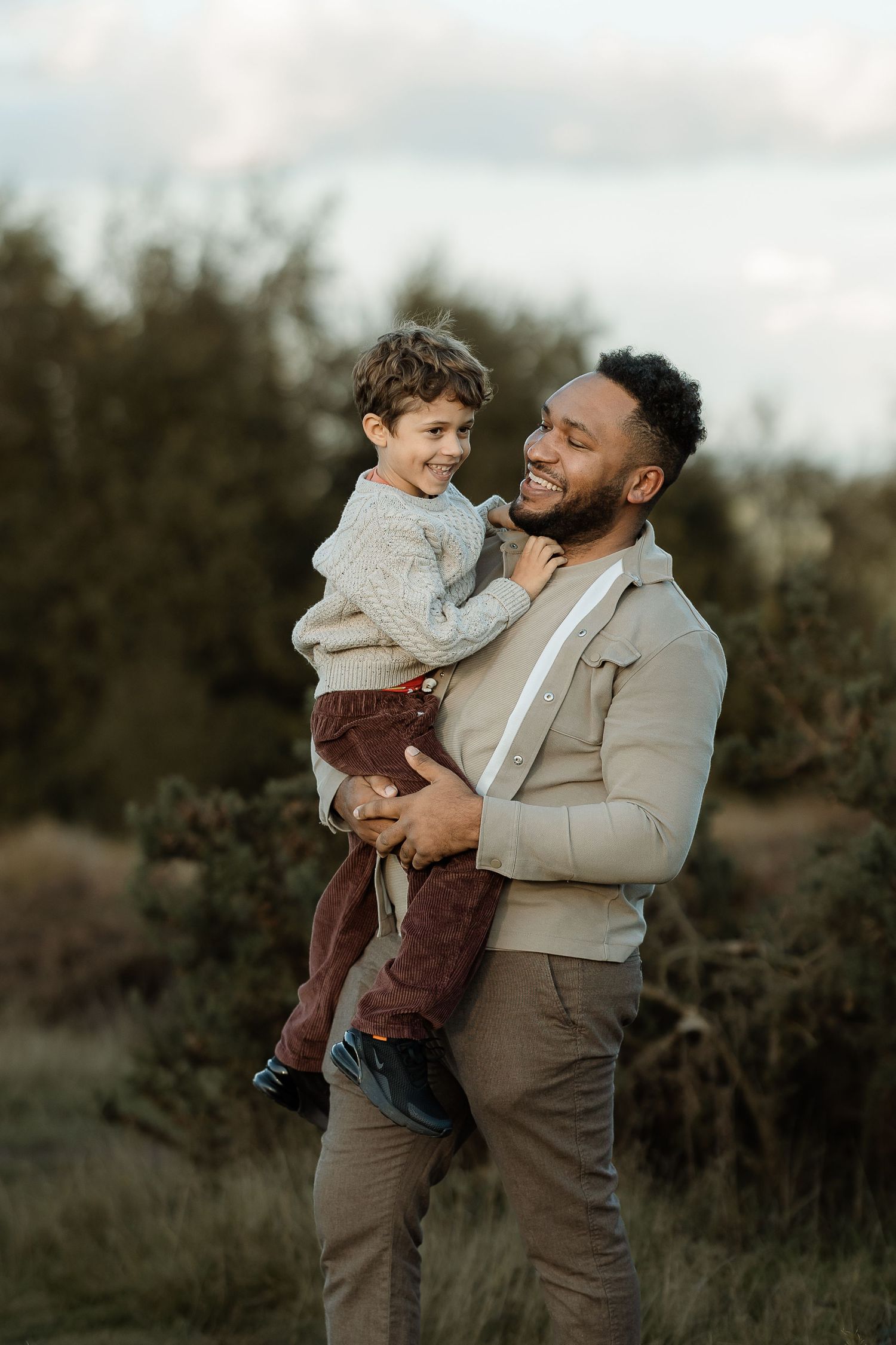 A parent and child share tender moments outdoors in a series of candid photos at dusk.