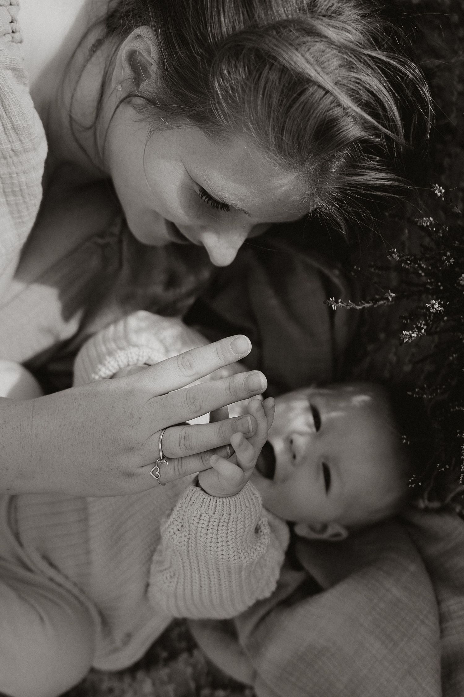 A tender black and white photo sequence showing a loving embrace between two people in soft lighting.
