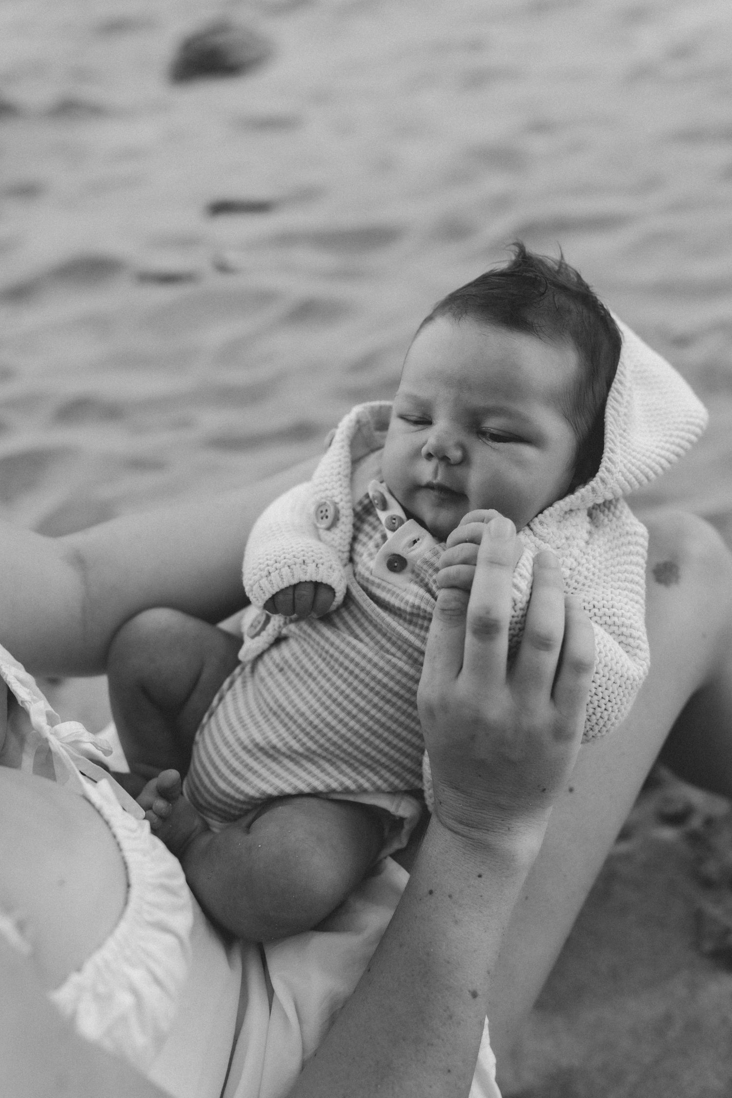 A peaceful black and white portrait captured on the beach at sunset.