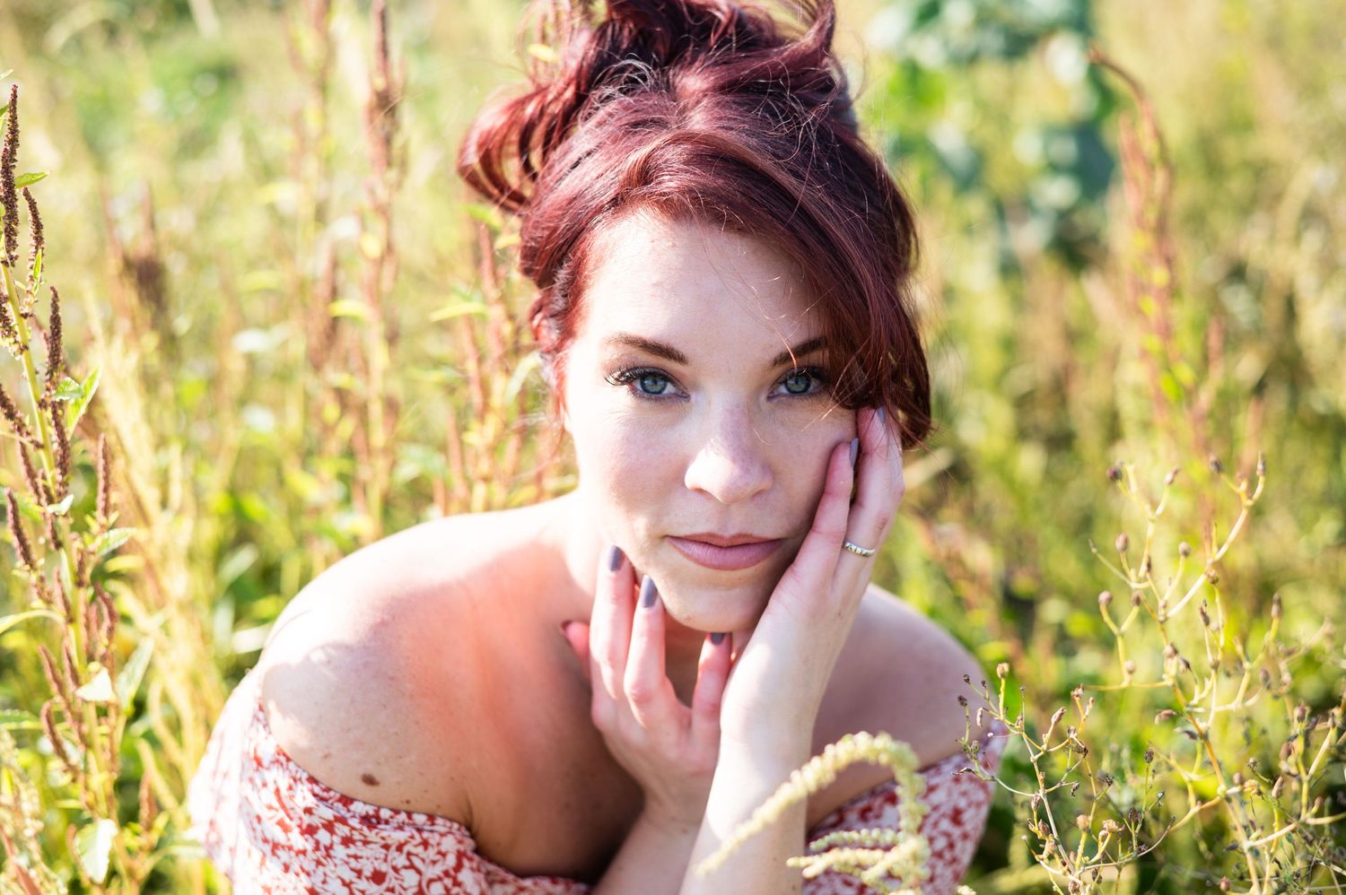 Romantic portrait among wildflowers with soft natural lighting.