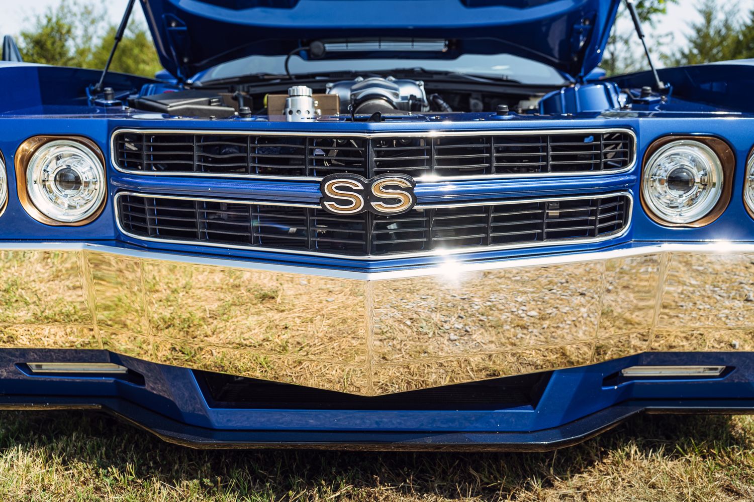 Close-up of blue Chevrolet SS muscle car front grille with chrome details outdoors. Watertown TN
