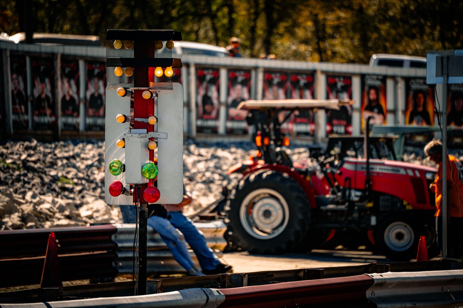 Drag racing Christmas tree starting light system with red tractor and spectator fence in background. Sick Smokies