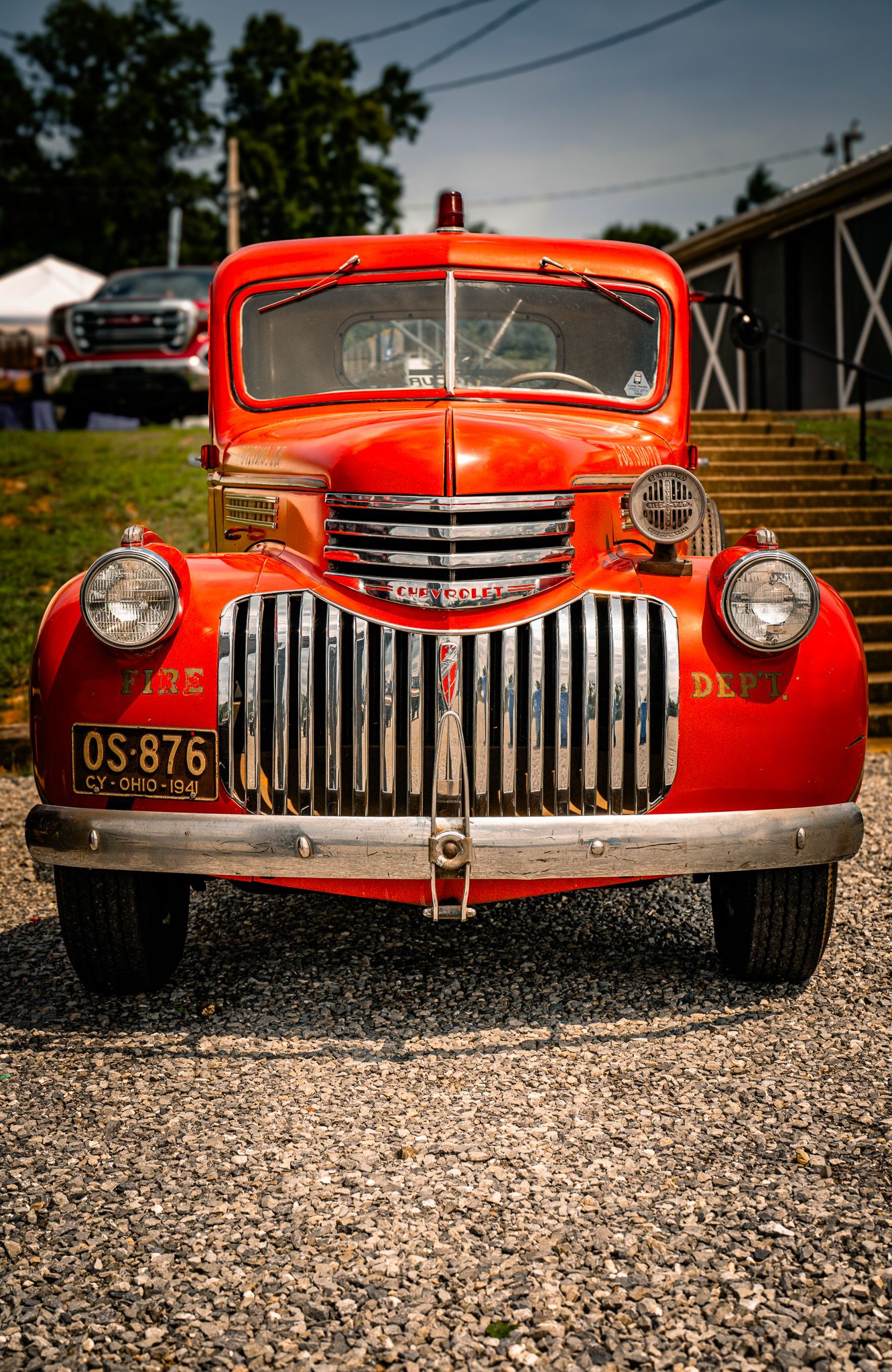 Vintage red Chevrolet fire truck with chrome grille and OS-876 license plate at show. GM Truck Fair