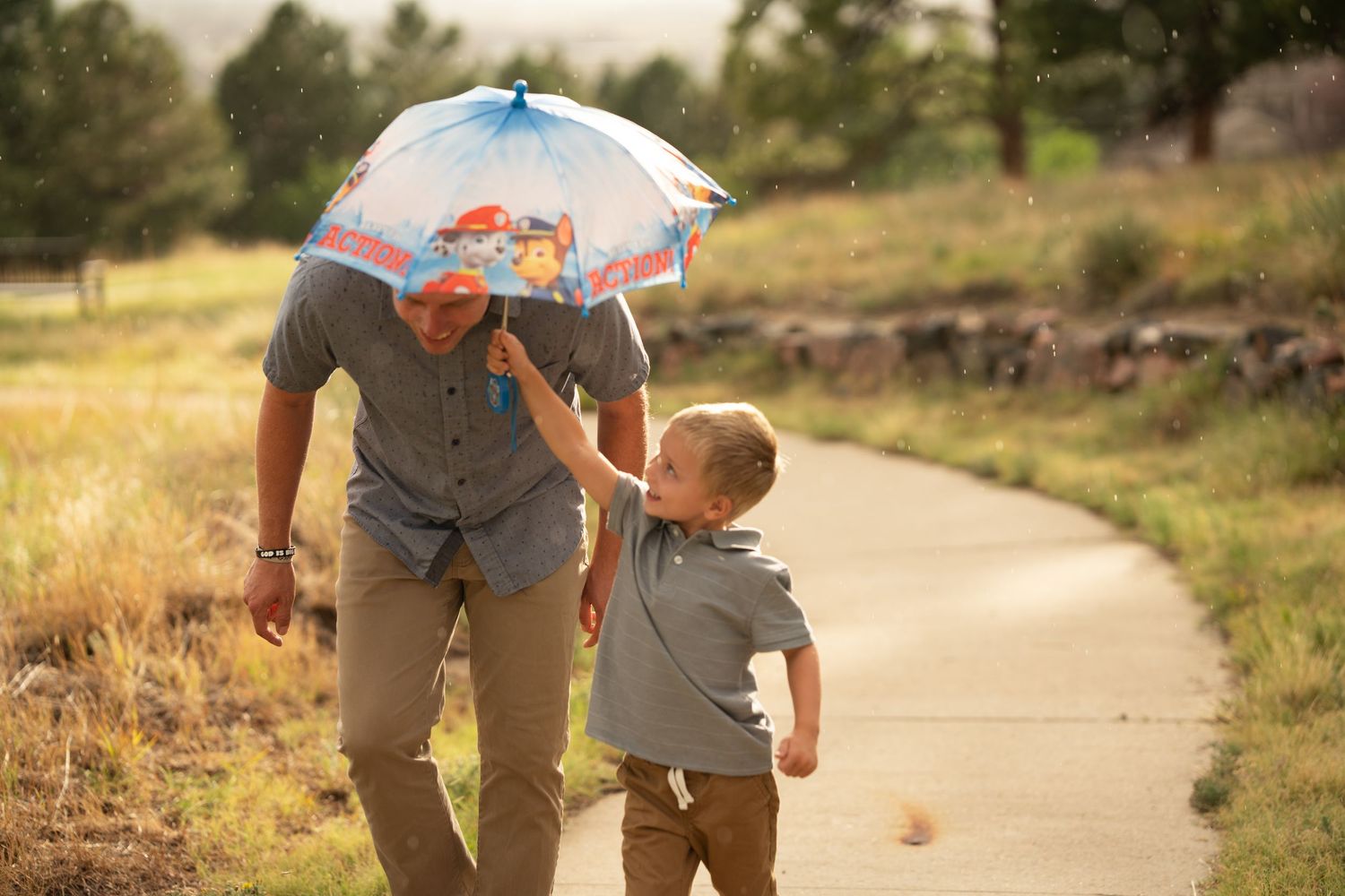 Umbrella, dad, and son.