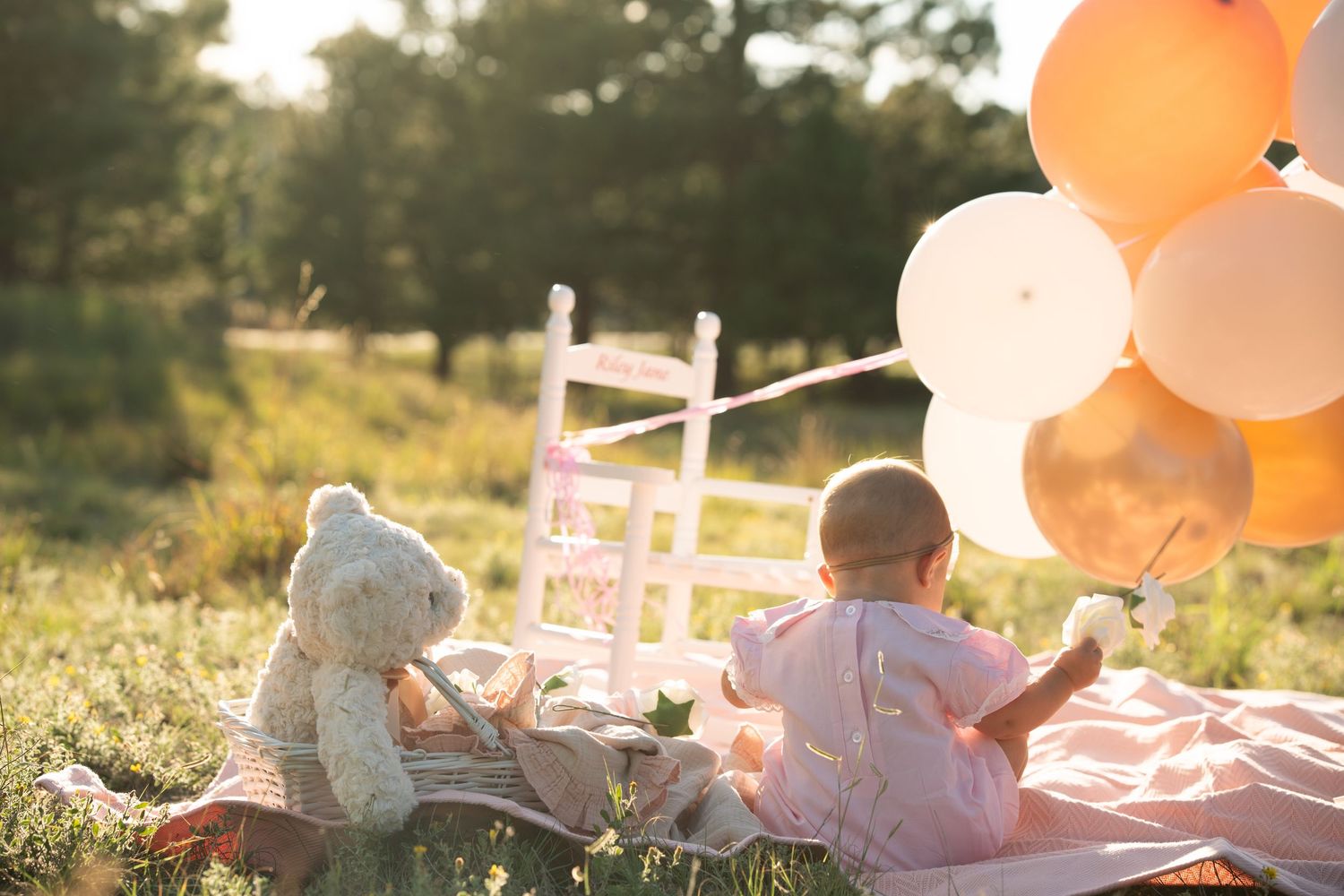 Baby, bear, balloons.