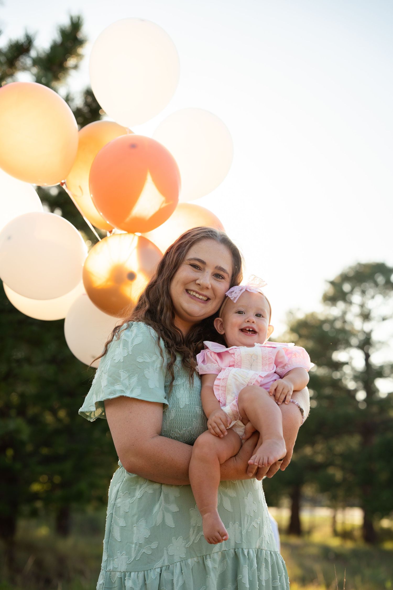 Mom, baby, balloons.