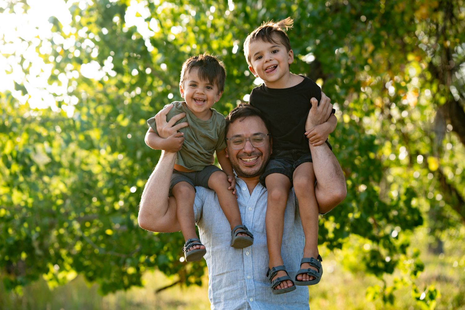 Dad has boys on shoulder