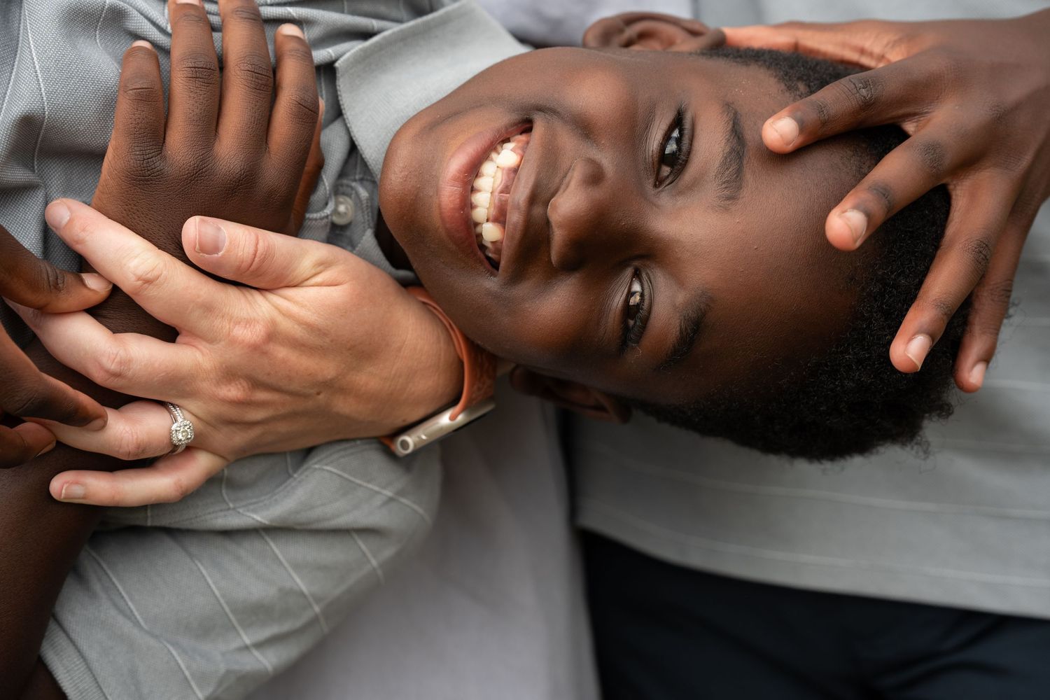 Son close up with hands.