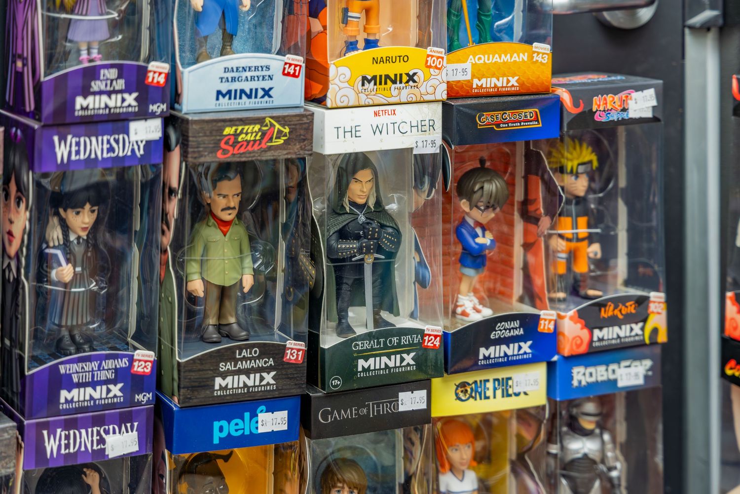 Collection of MINIX figurines in boxes featuring Wednesday, The Witcher, Game of Thrones, Naruto, and One Piece characters.