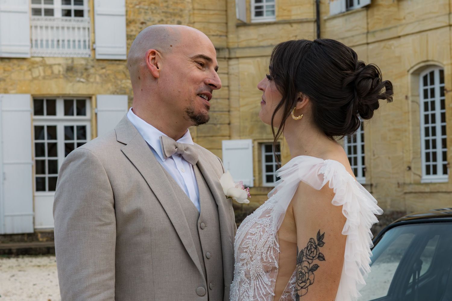 Bride and groom share a romantic moment outside a French chateau on their wedding day.