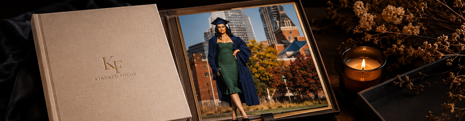Elegant linen photo album with graduation portraits displayed on dark background with candle.
