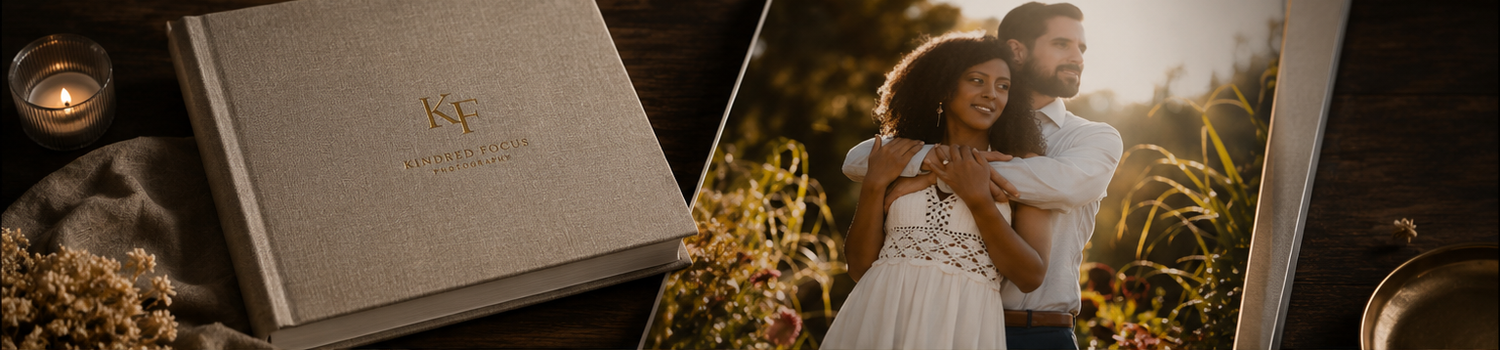 An elegant wedding photo album beside a romantic couple portrait in a field.