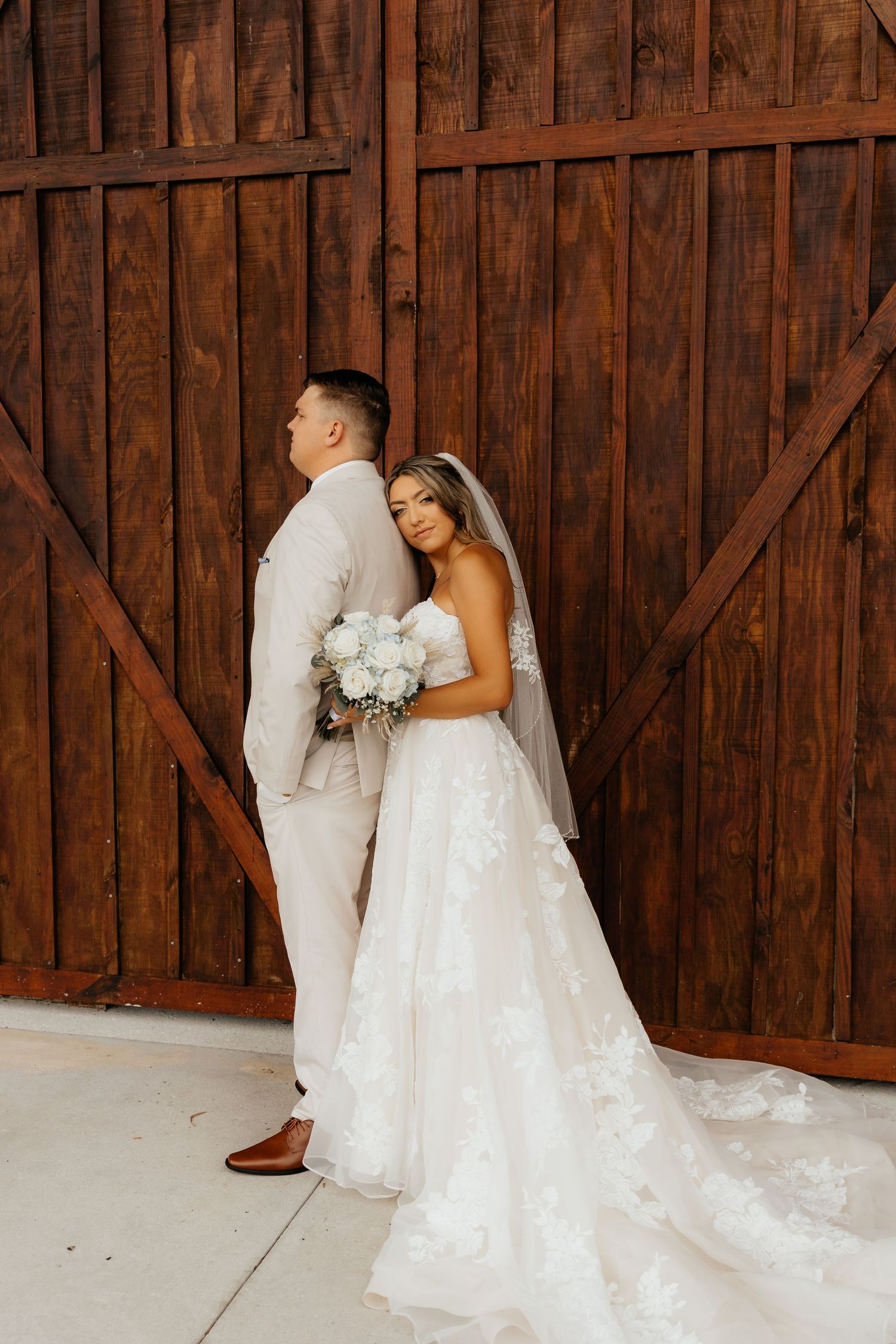 Rustic Florida wedding at barn in Okeechobee, Bride & groom standing in front of barn door