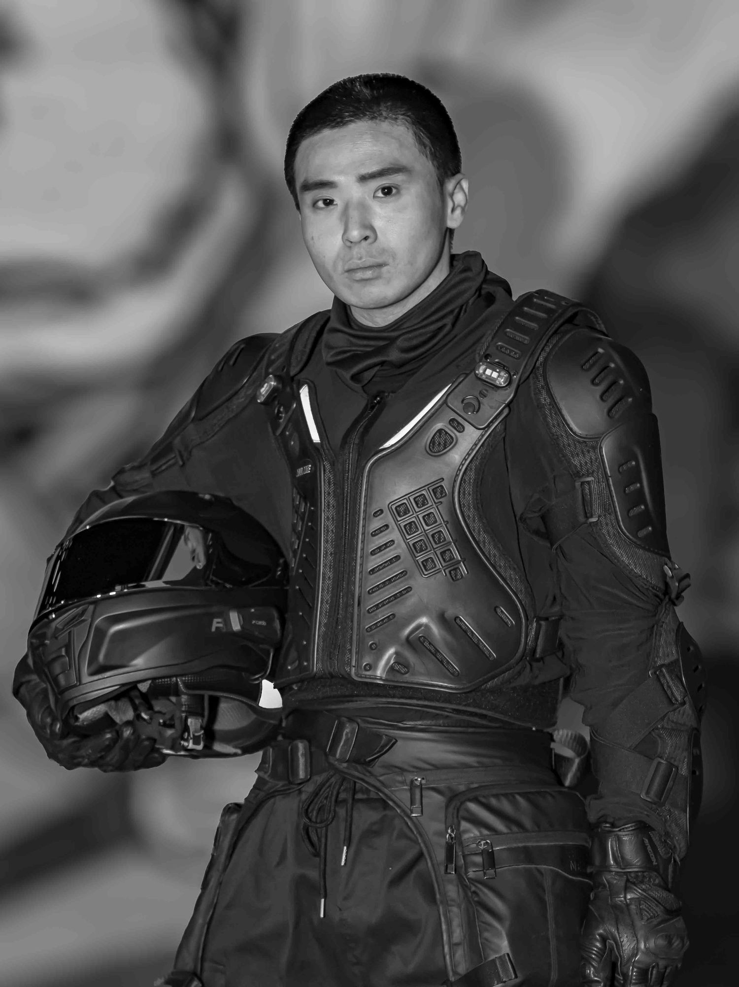Tactical gear and protective equipment worn in dramatic black and white photography.