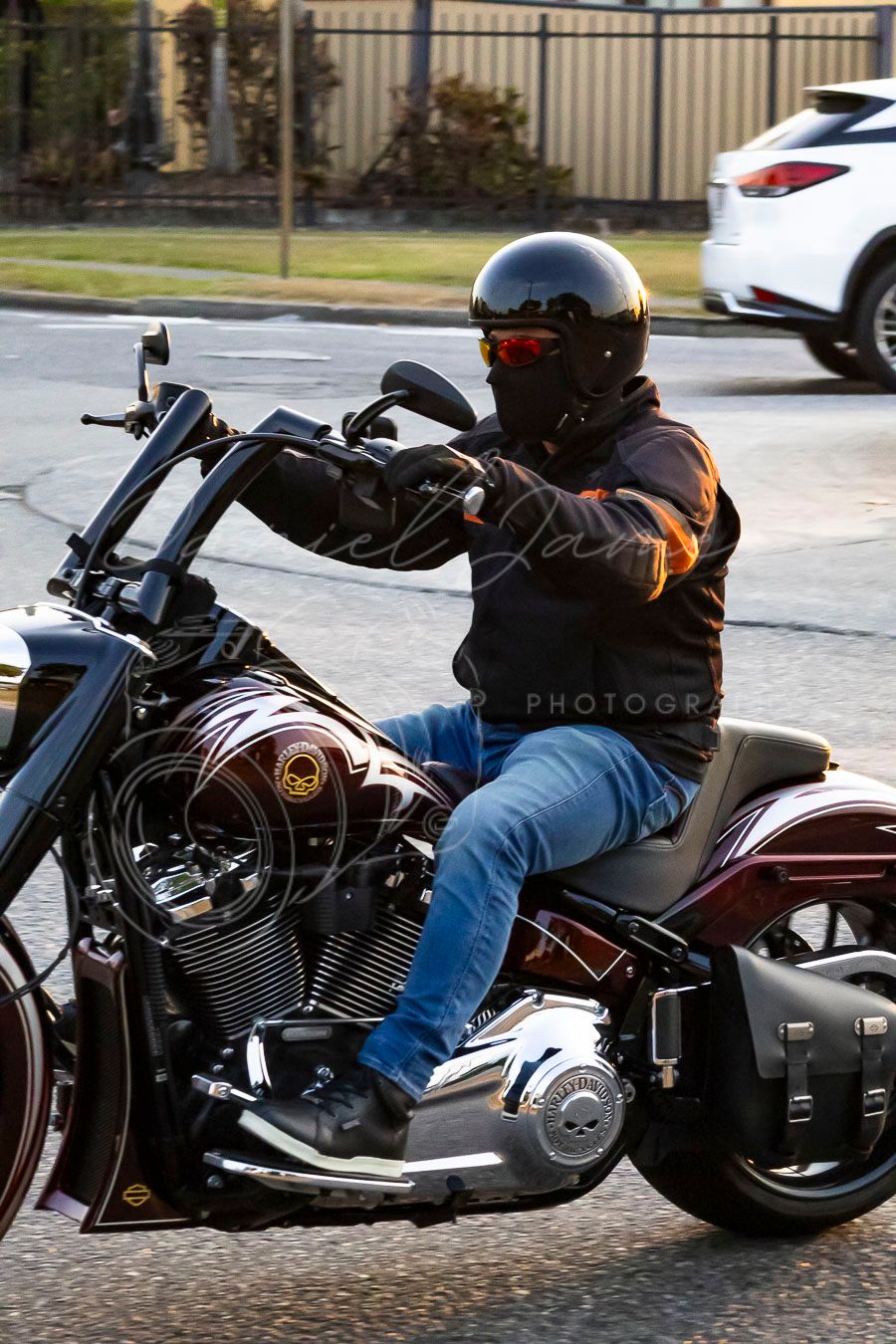 Custom cruiser motorcycle in low riding position with extended front forks on urban street.