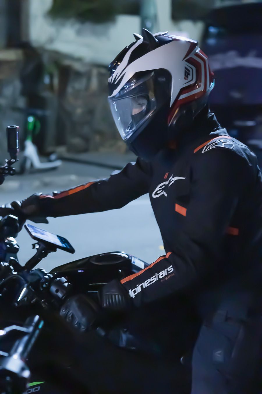 Motorcyclists in protective gear preparing for a night ride.