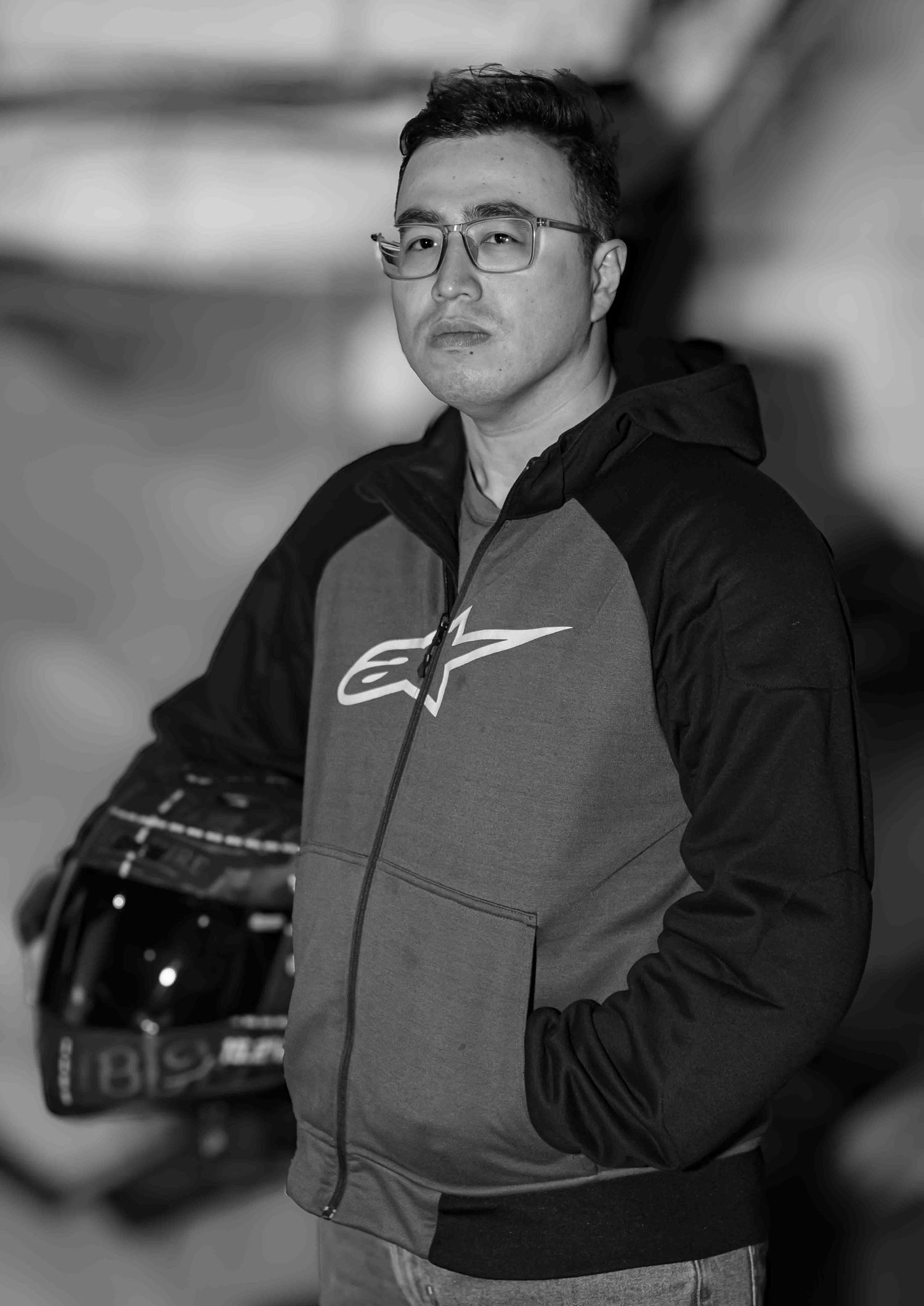 Person wearing Nike apparel and glasses in black and white portrait series.