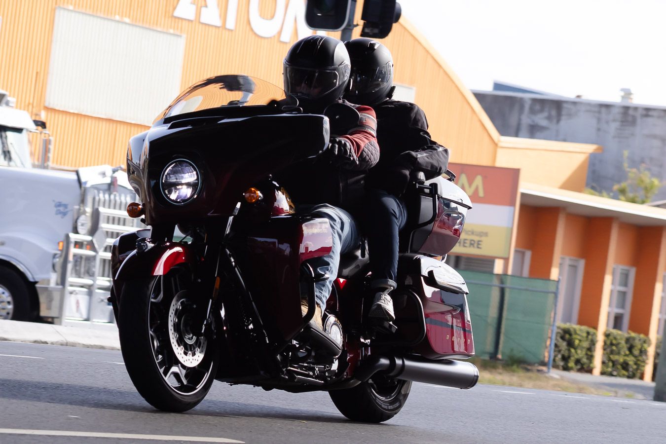Dark motorcycle silhouettes against urban background during street ride.