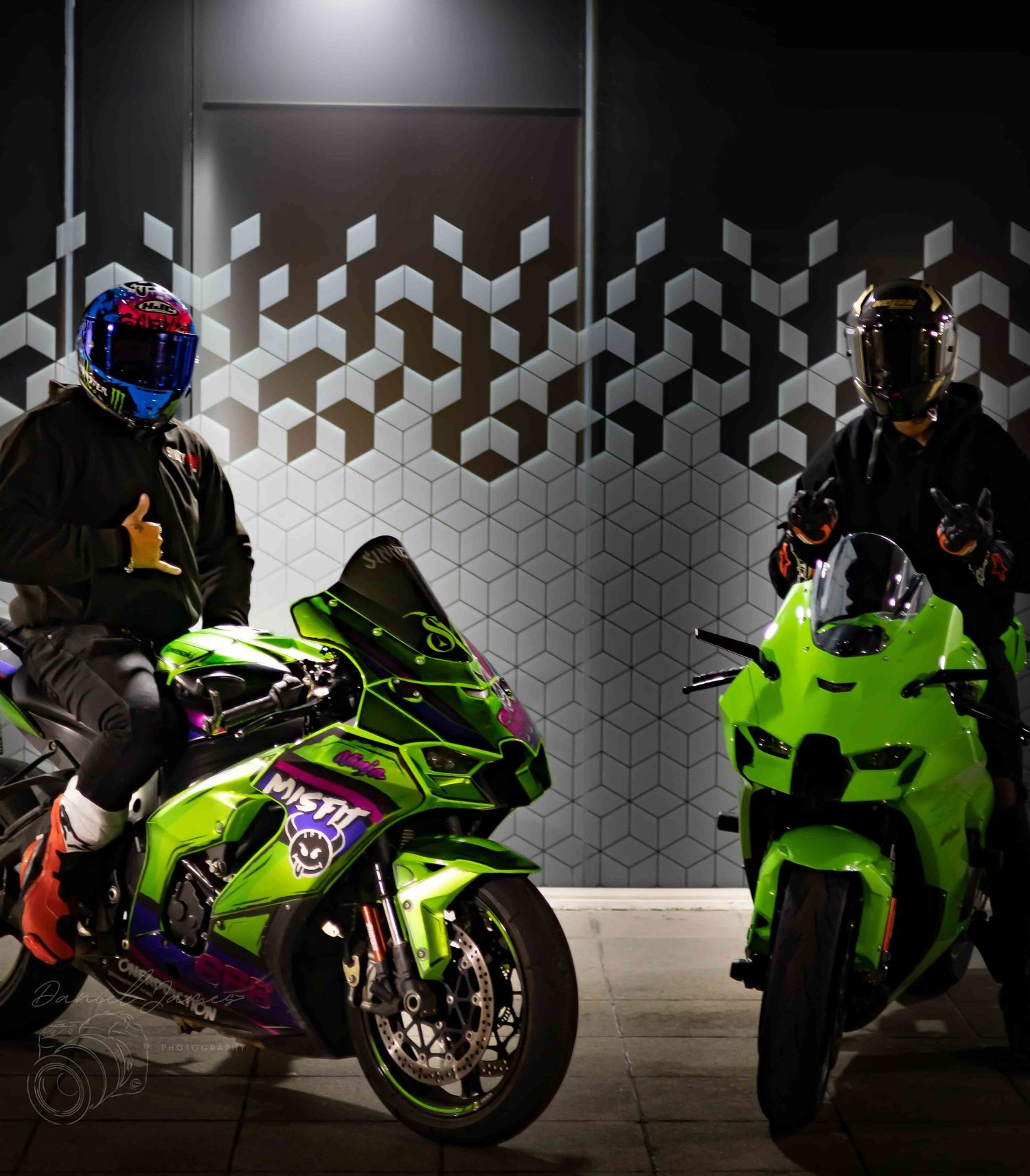 Collection of sport bikes displayed against a geometric patterned wall with dramatic lighting.