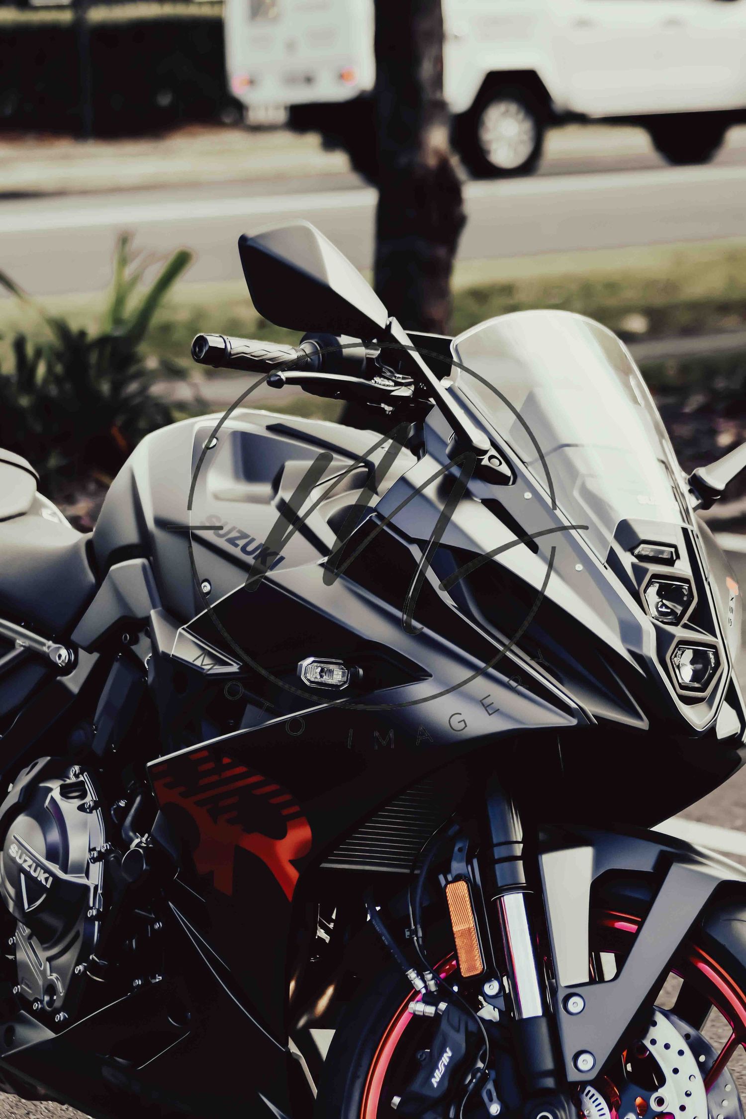 Close-up of a sleek black Yamaha sport motorcycle parked outdoors with red accents and aerodynamic fairing.