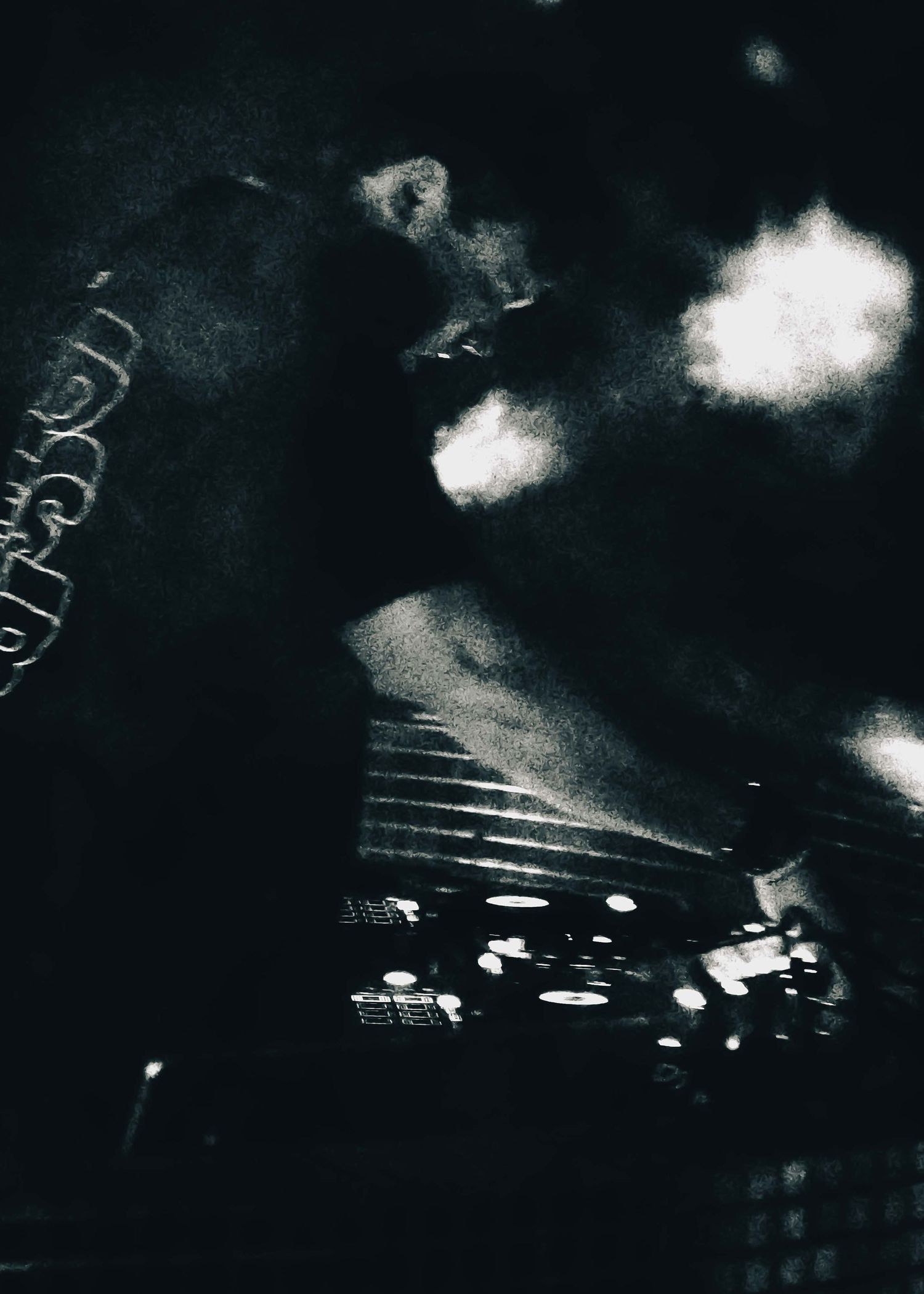 Dark atmospheric stage with dramatic lighting and smoke effects.