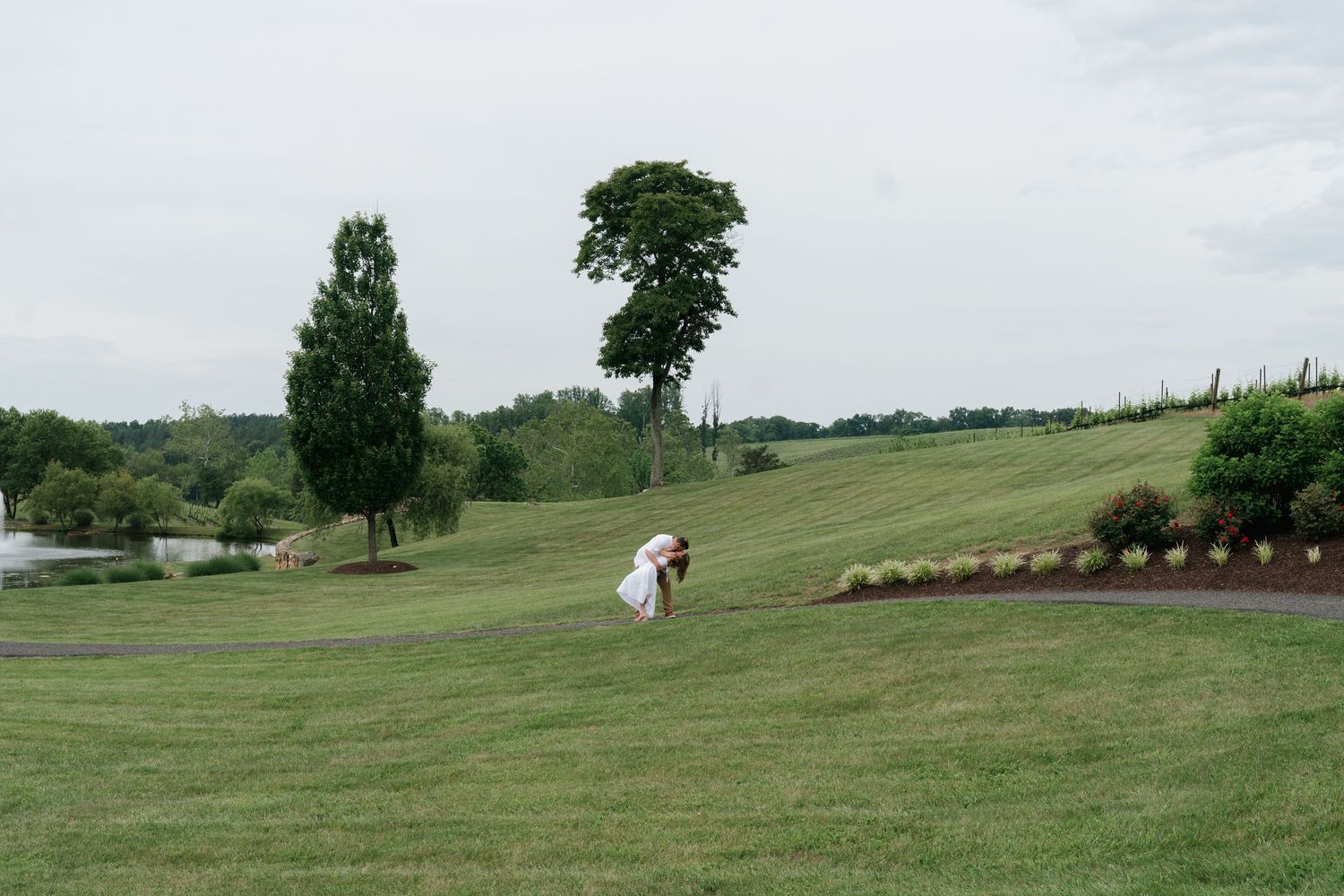 An engaged couple shares a romantic embrace at Stone Tower Winery in Leesburg, Virginia.