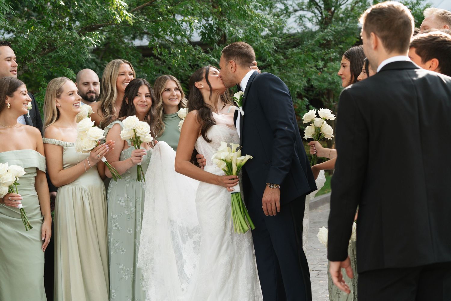 Couple kissing surrounded by bridesmaids and groomsmen at Chesapeake Bay Beach Club, on Kent Island in Maryland