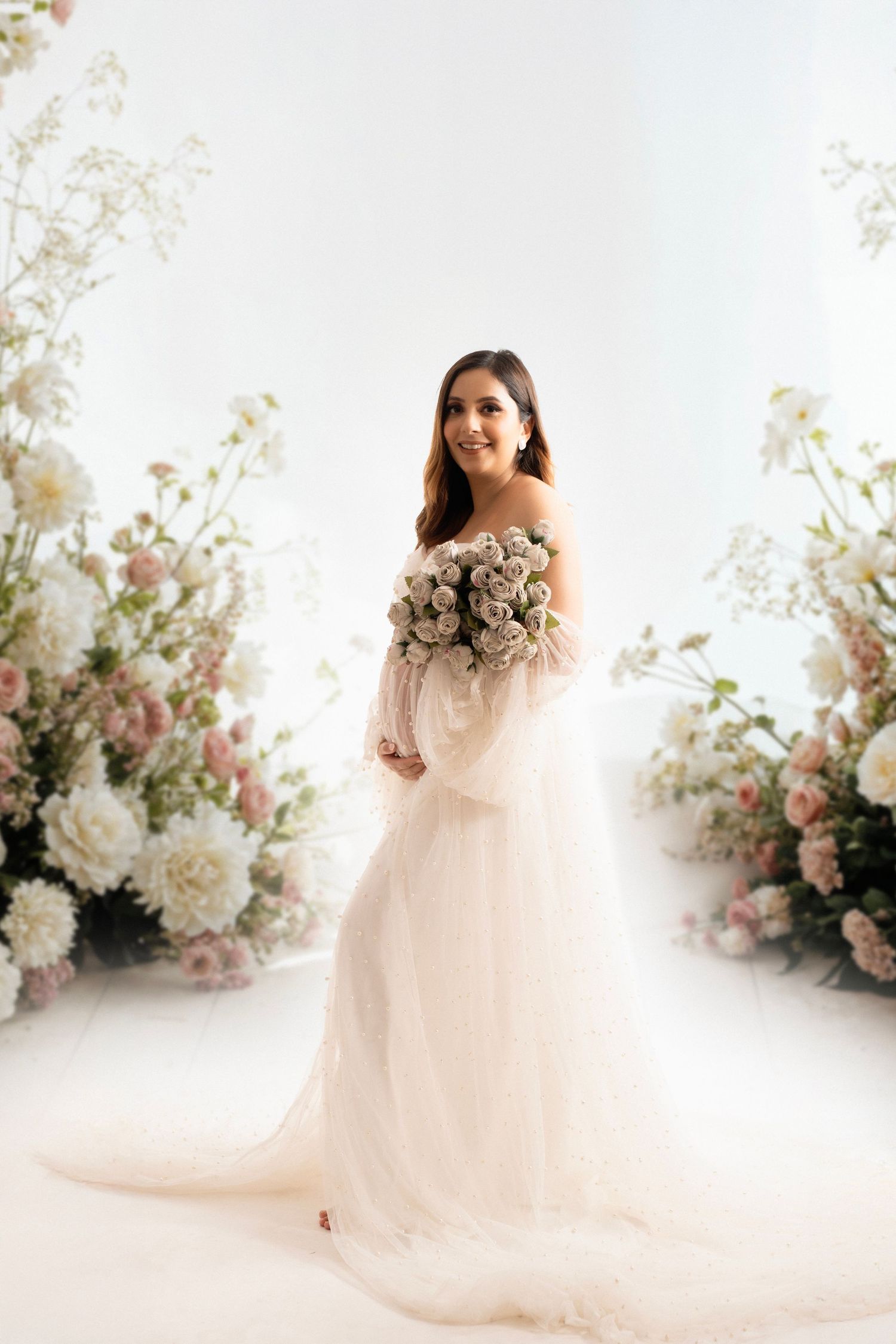 Ethereal pink and white floral photography backdrop with soft tulle dress details and delicate flower arrangements.