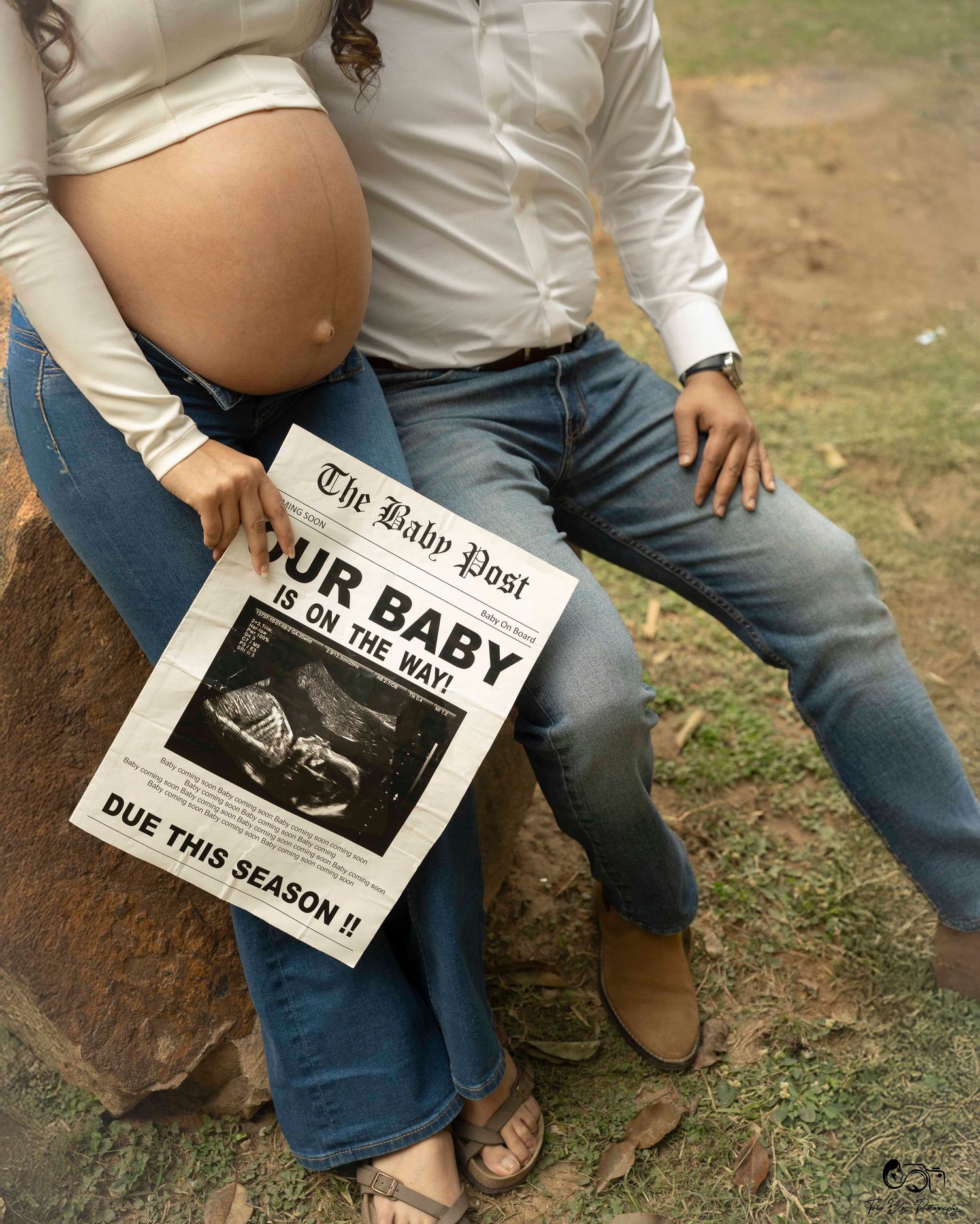 A person in blue jeans and white top holds a newspaper while sitting on the ground in multiple poses.