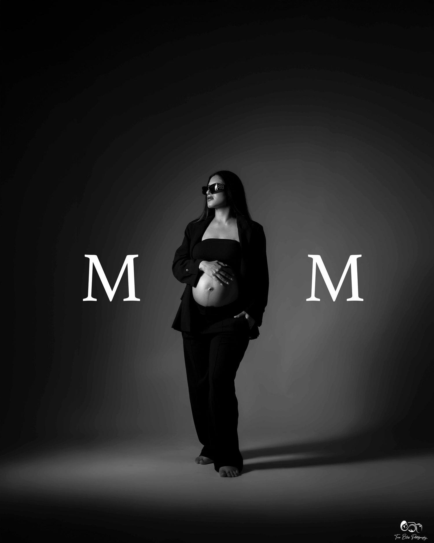 Artistic black and white photo series showing silhouette of figure in dark clothing against gradient background with letter M.
