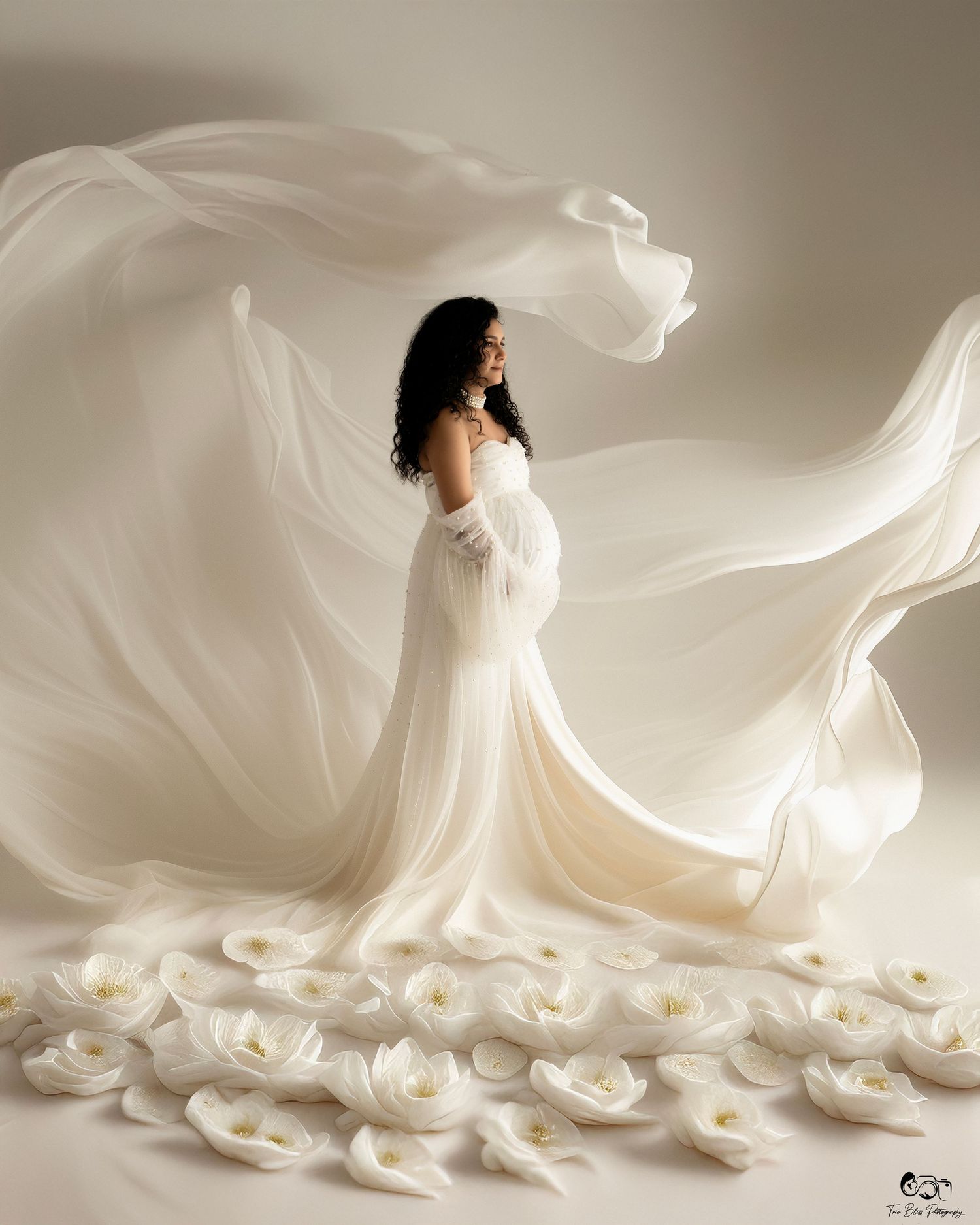 Artistic wedding photography sequence showing flowing white dress movement with scattered rose petals in studio setting.