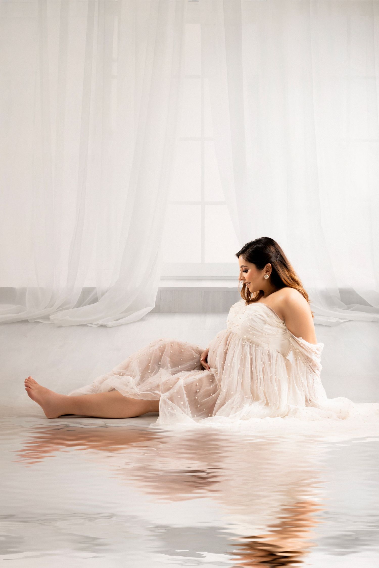 Ethereal photo series showing a figure in flowing white fabric reclining gracefully against reflective water surfaces.