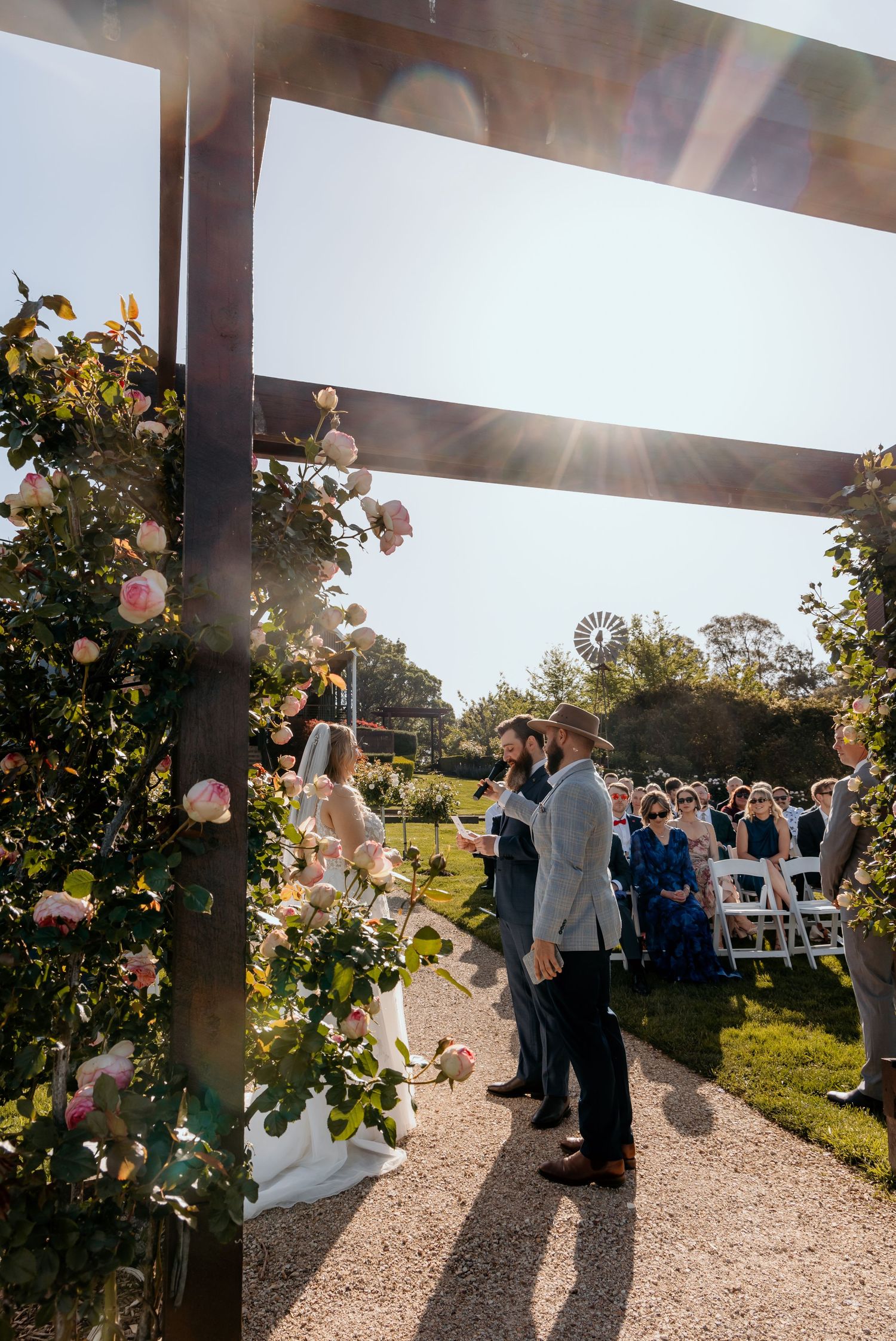 Sequence of outdoor wedding ceremony photos showing guests gathered under wooden beams with sunlight streaming through.