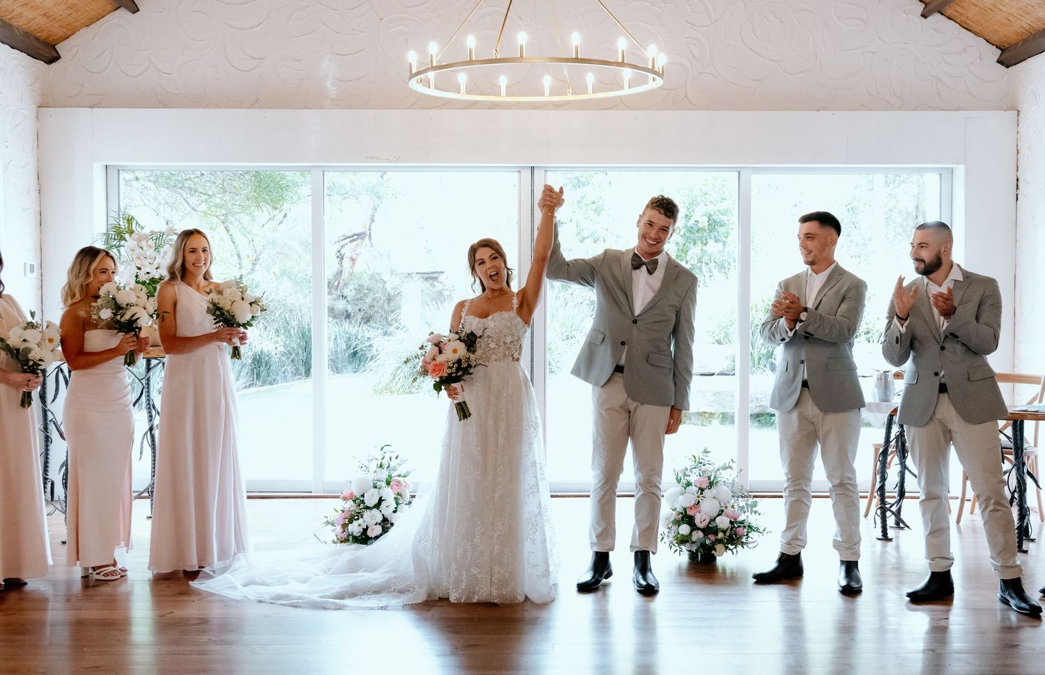A panoramic wedding party sequence showing multiple moments at an elegant white venue with tan and beige color scheme.